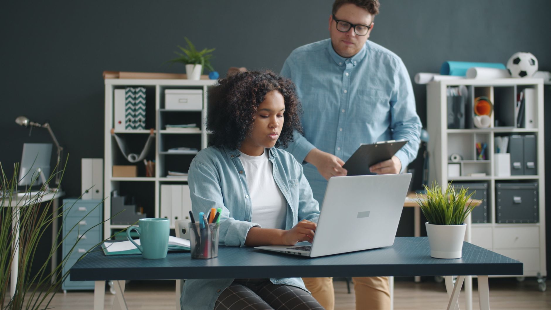 Two business professionals collaborating in a contemporary office setting.