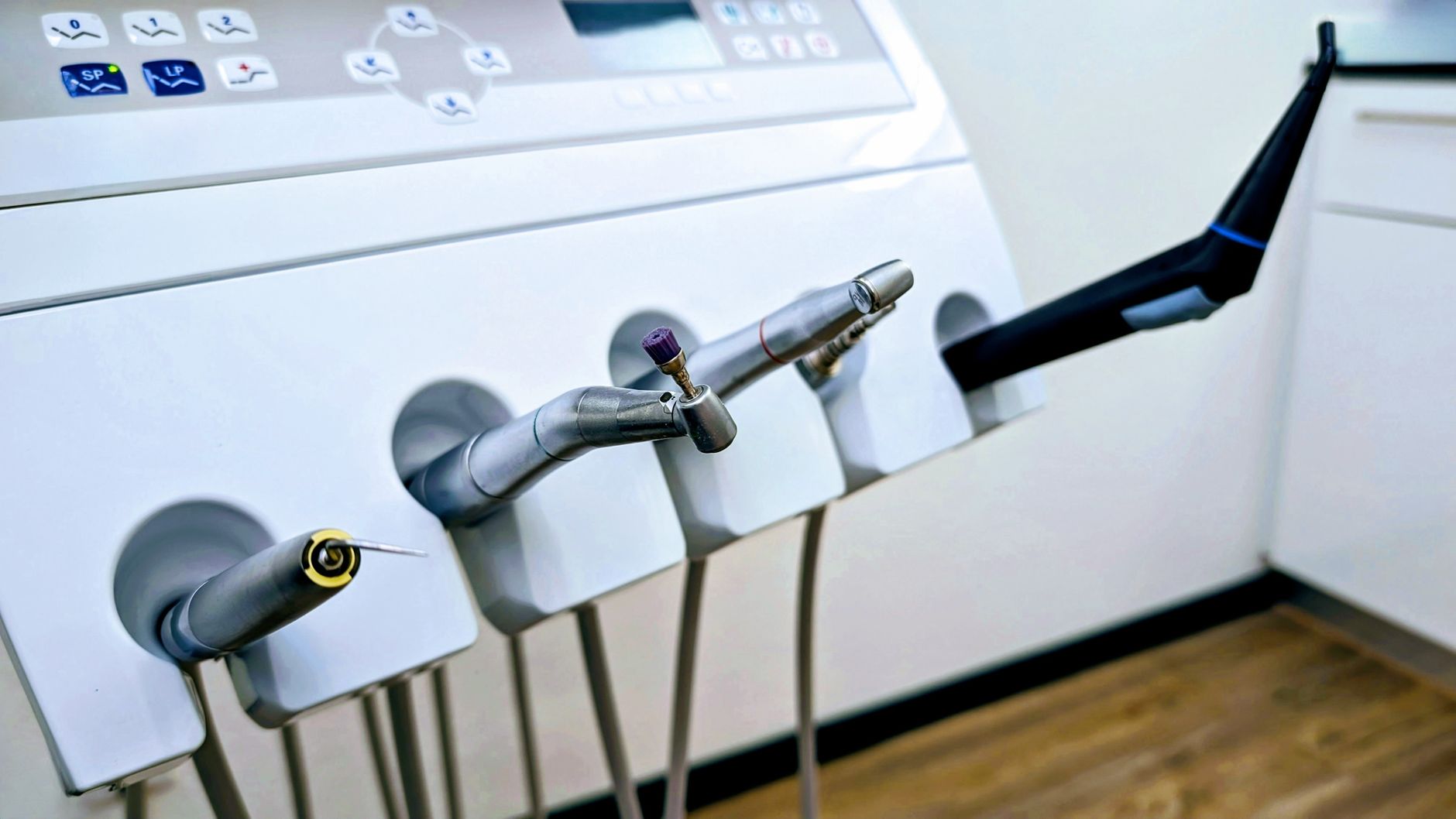 Close-up of dental instruments in a professional dental clinic setting.