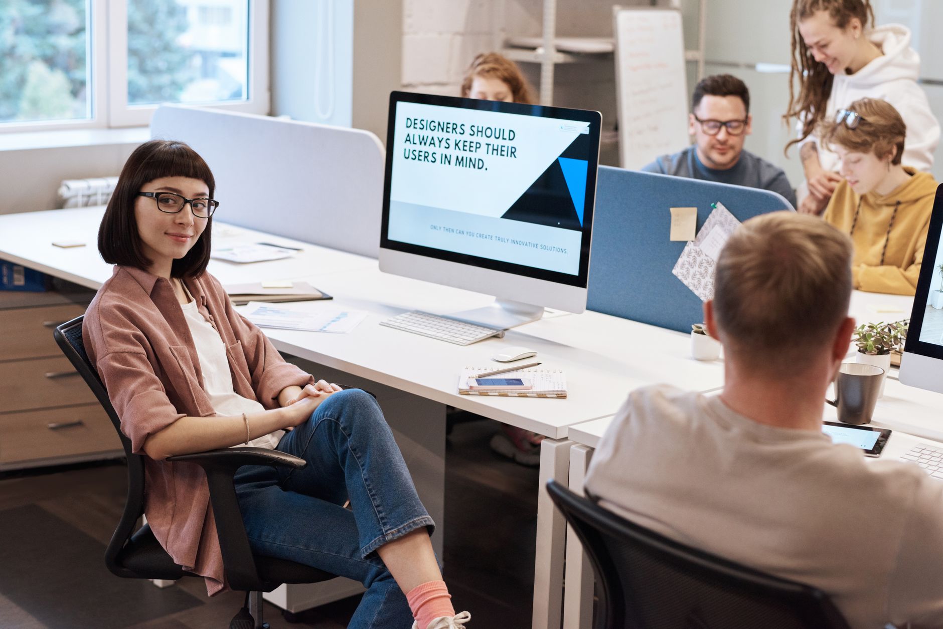 Team of young professionals collaborating in a modern office, fostering creativity and innovation.