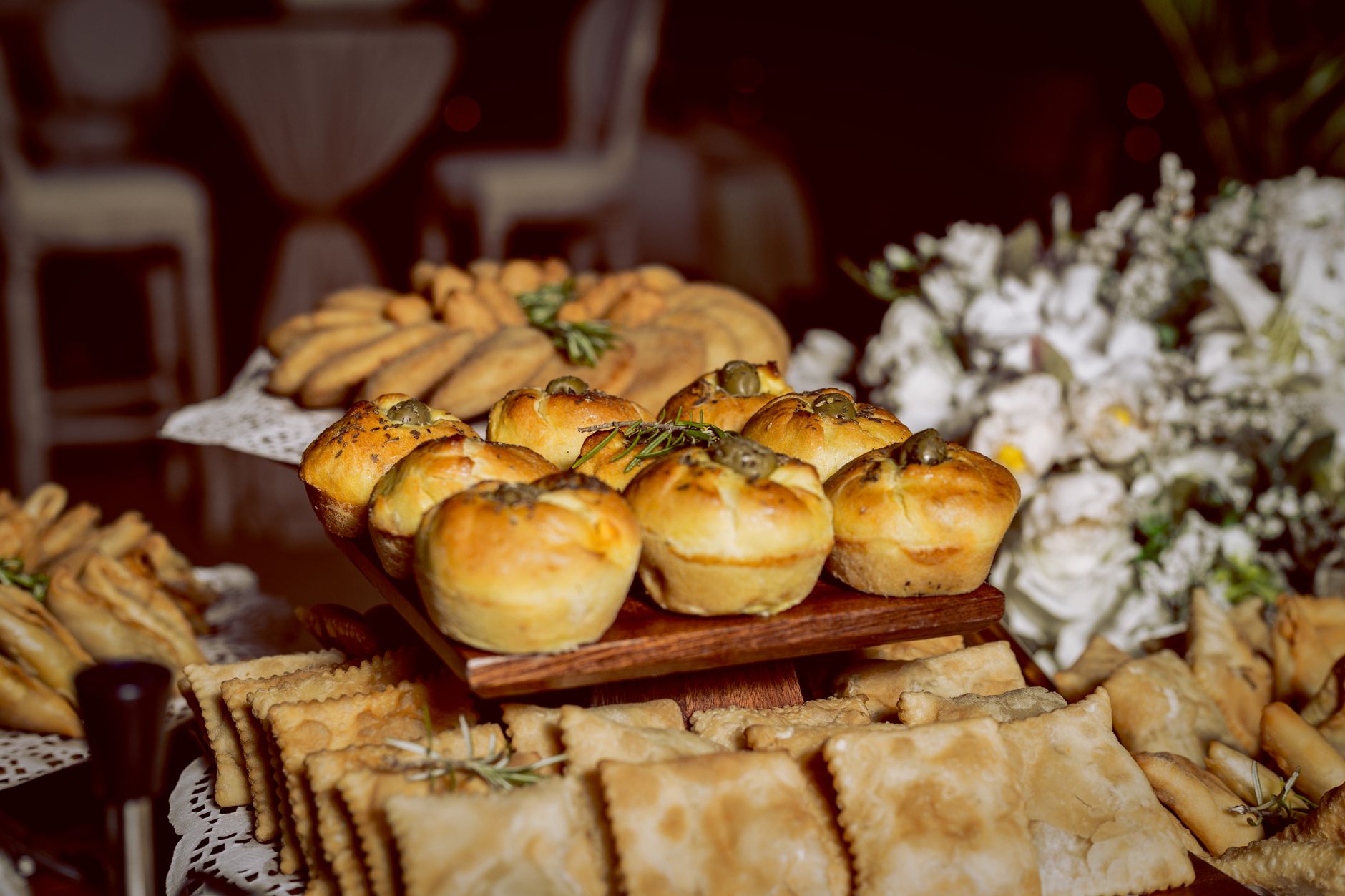 A variety of freshly baked pastries and breads artfully arranged at an event in Luanda, Angola.