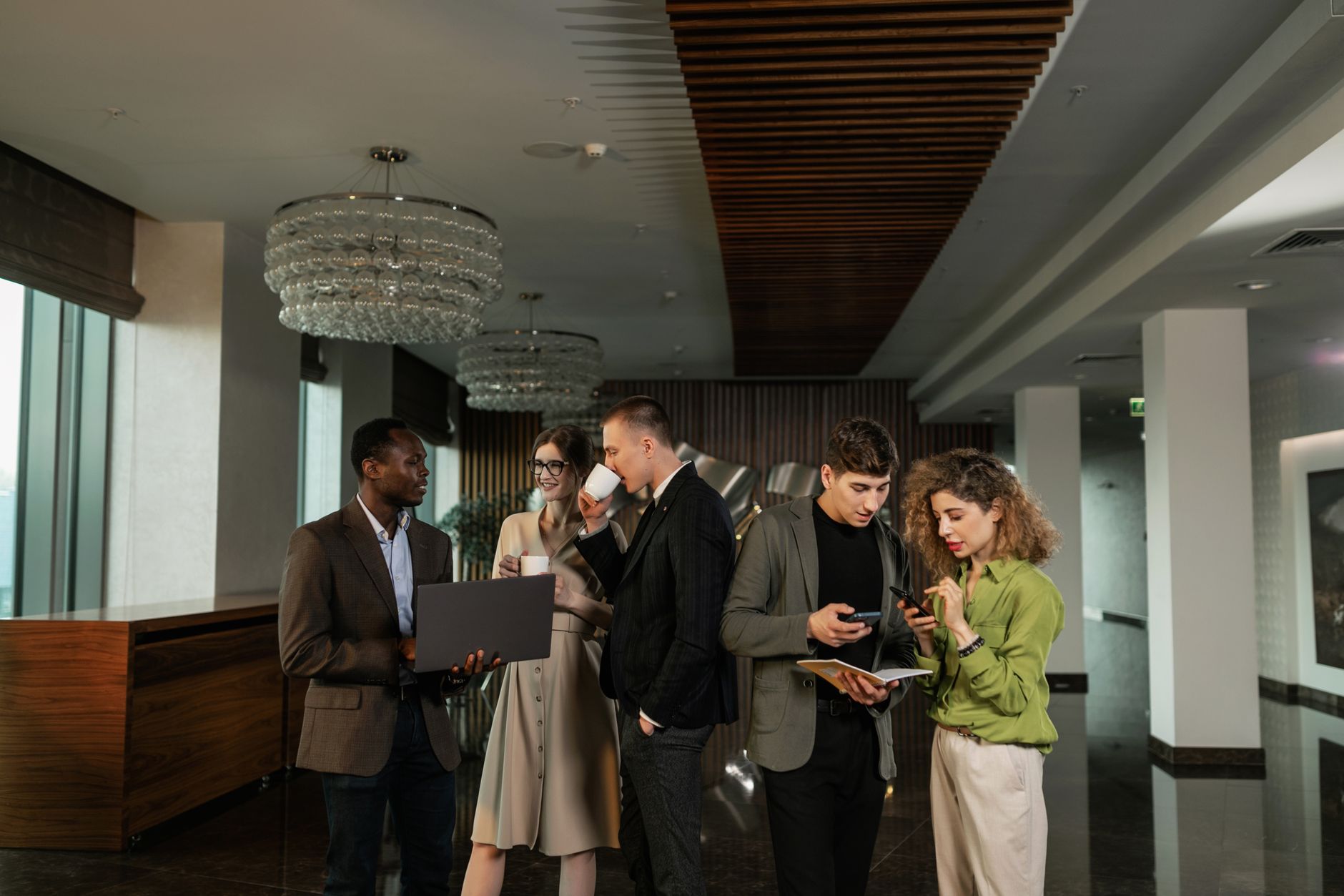 A diverse group of professionals discussing plans in a modern office setting.