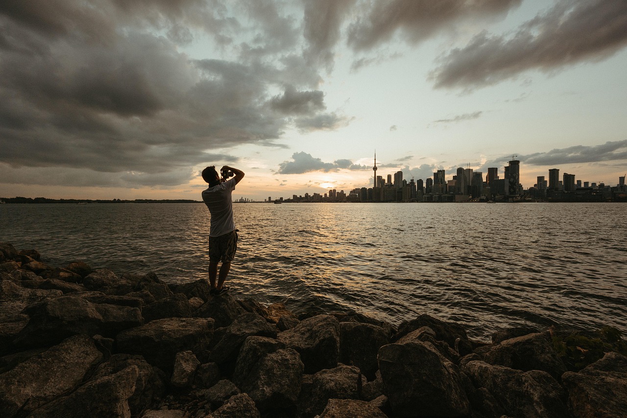 photographer, toronto, toronto skyline, city, lake, water, ocean, sunset, landscape, male photographer, man, camera, travel, moody, nature, moody clouds, dramatic light, photography, summer, spring, fall, golden tones, urban, buildings, peaceful