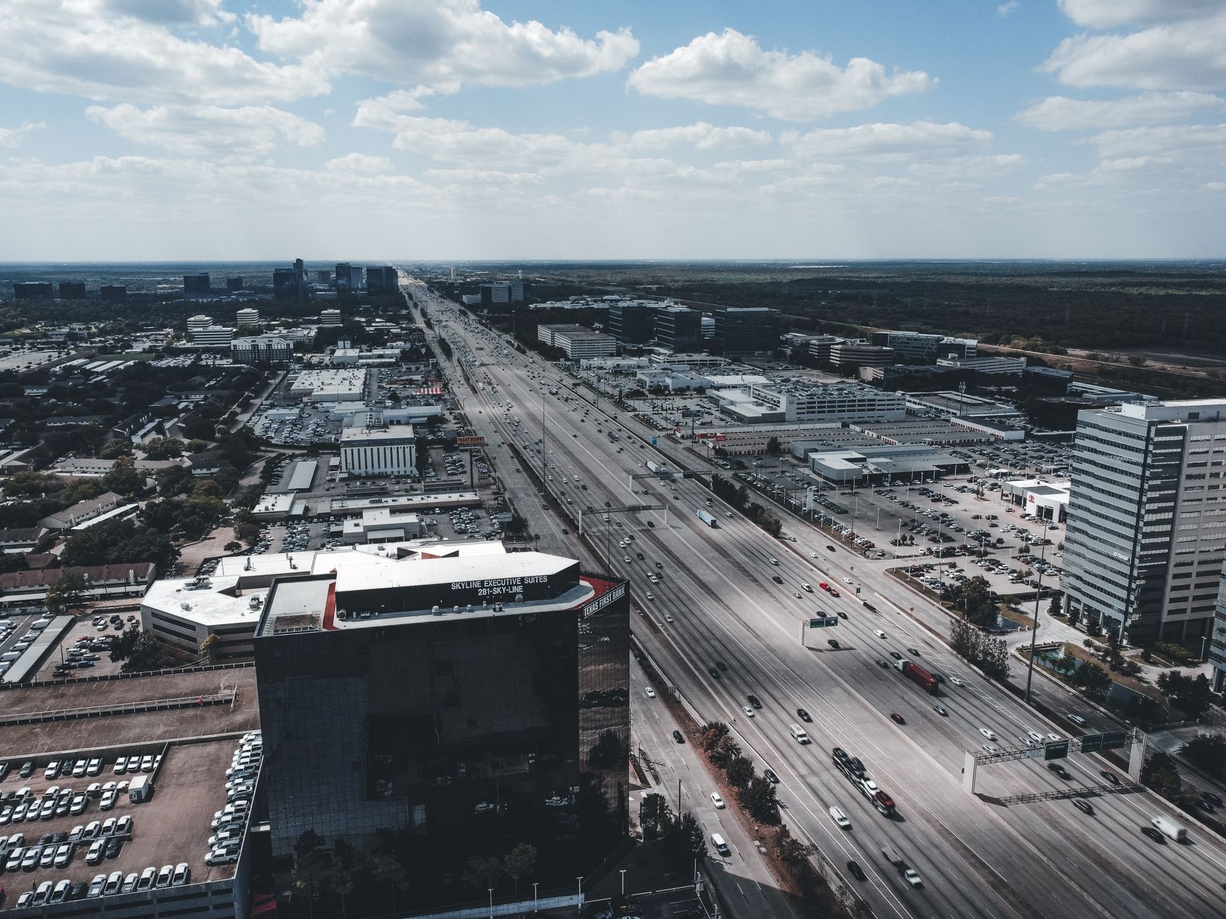 Aerial view showcasing a bustling expressway amidst modern architecture in a cityscape setting.