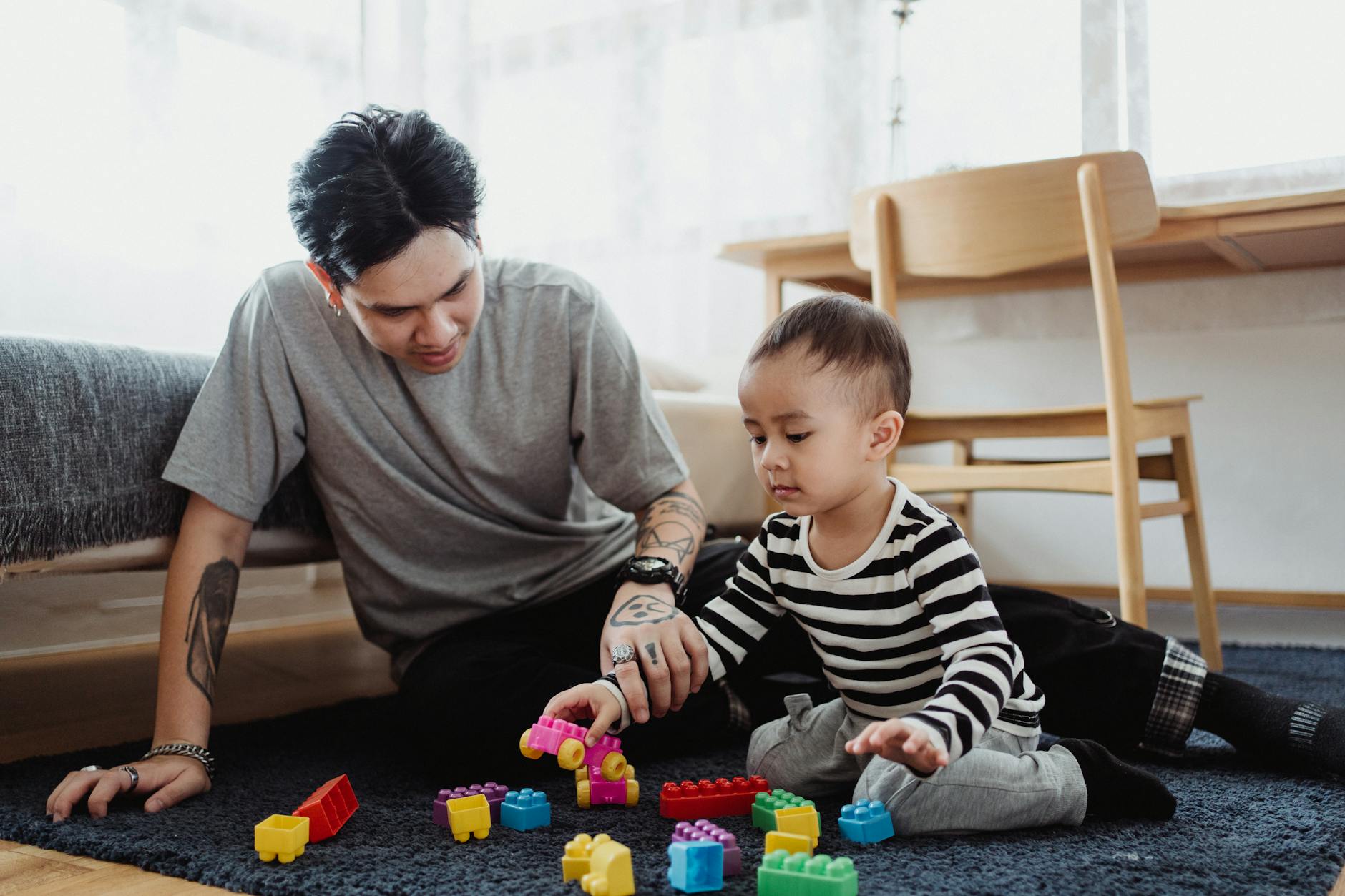 Daycare teacher engaging toddlers in colorful classroom