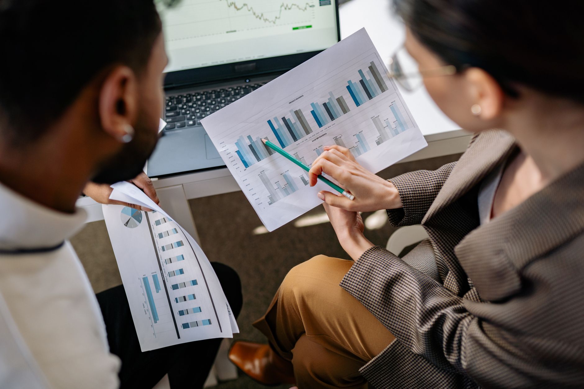 Business team reviewing live chat analytics and pricing reports
