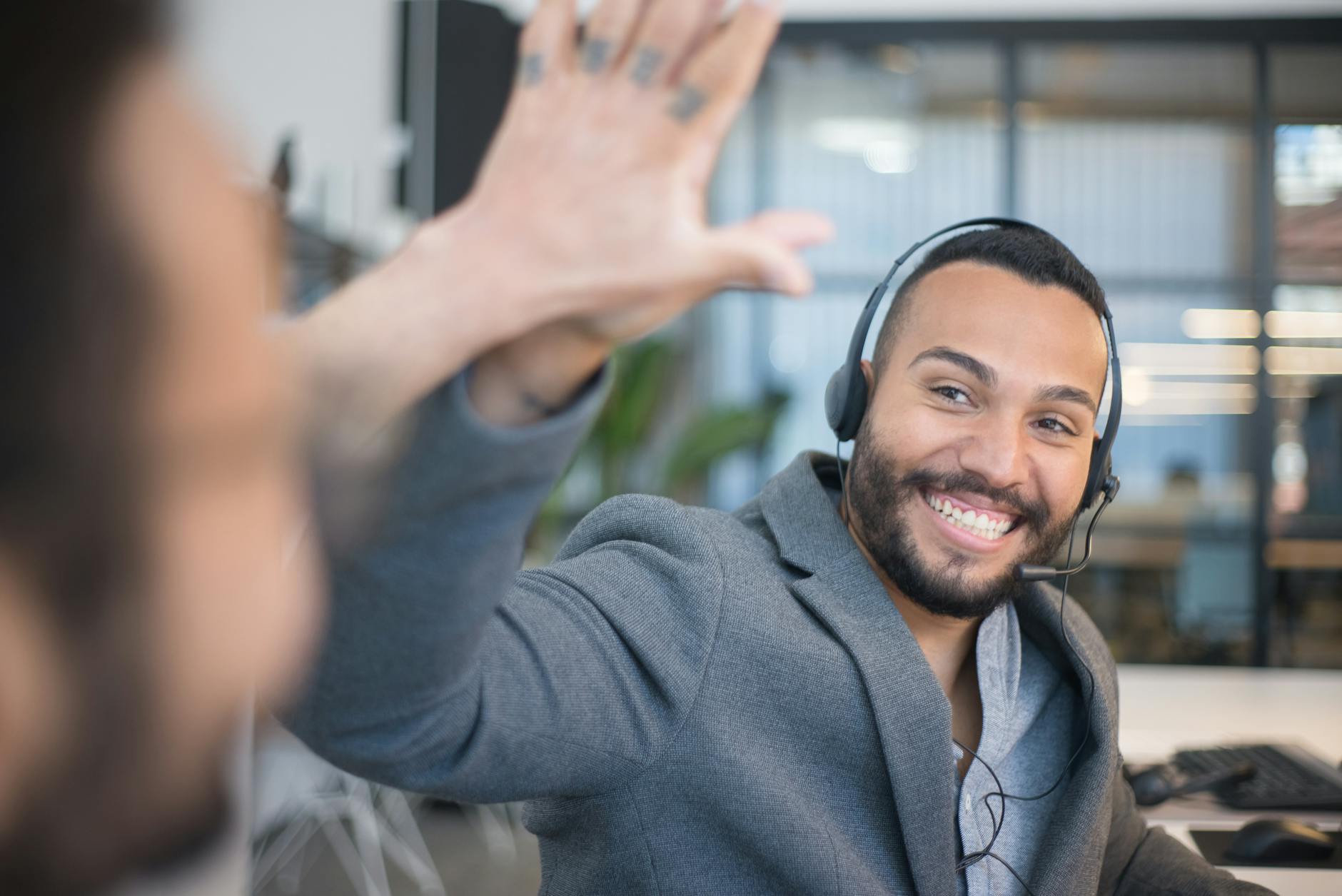 Miami sales team celebrating deal closure in modern office