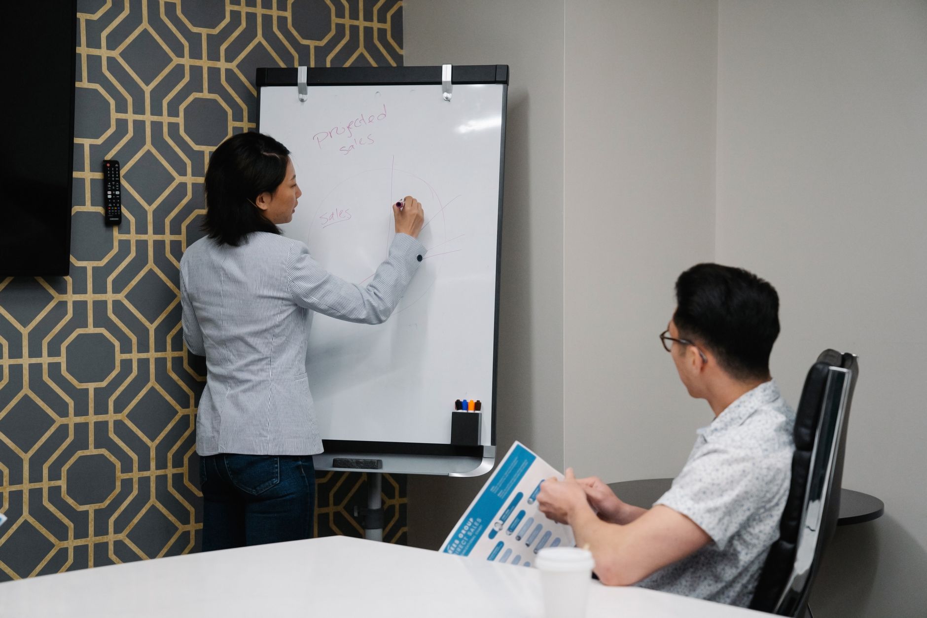 SEO agency meeting in a modern New York conference room with whiteboard and laptops