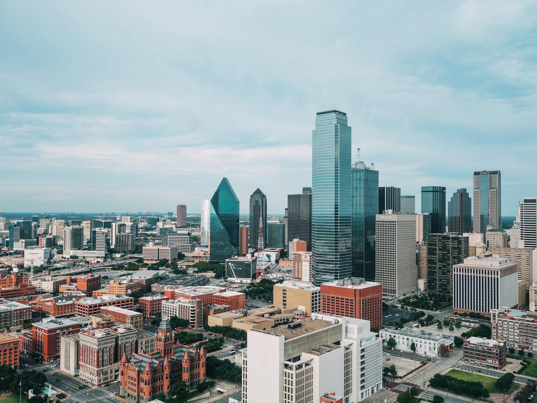 Dallas skyline with digital AI revenue graphs overlay