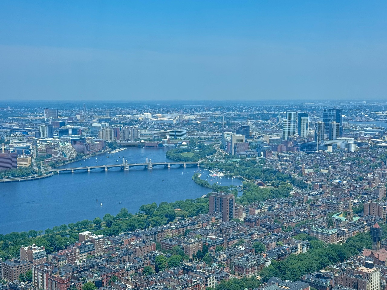 Boston skyline with professionals analyzing revenue dashboards in tech office