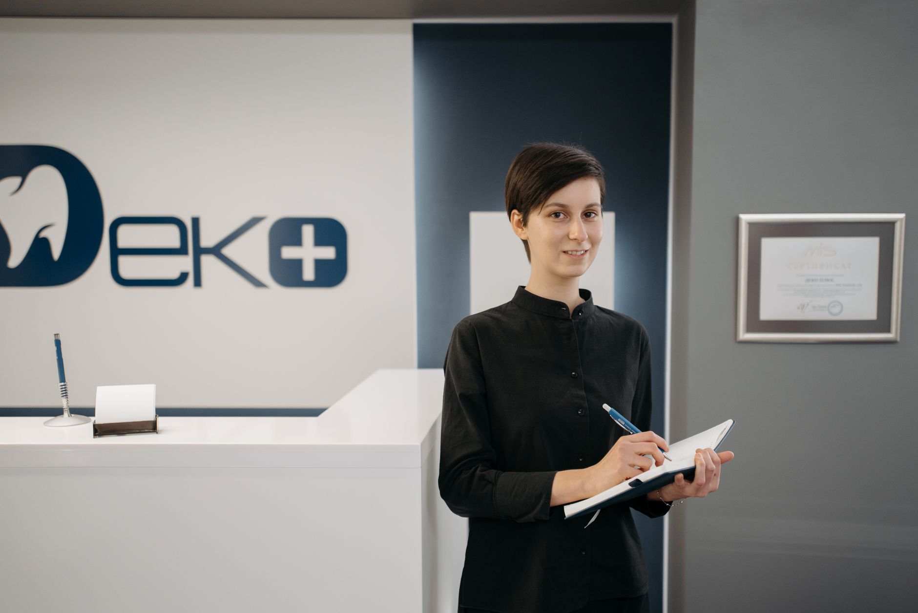 Dental clinic reception area with patients waiting