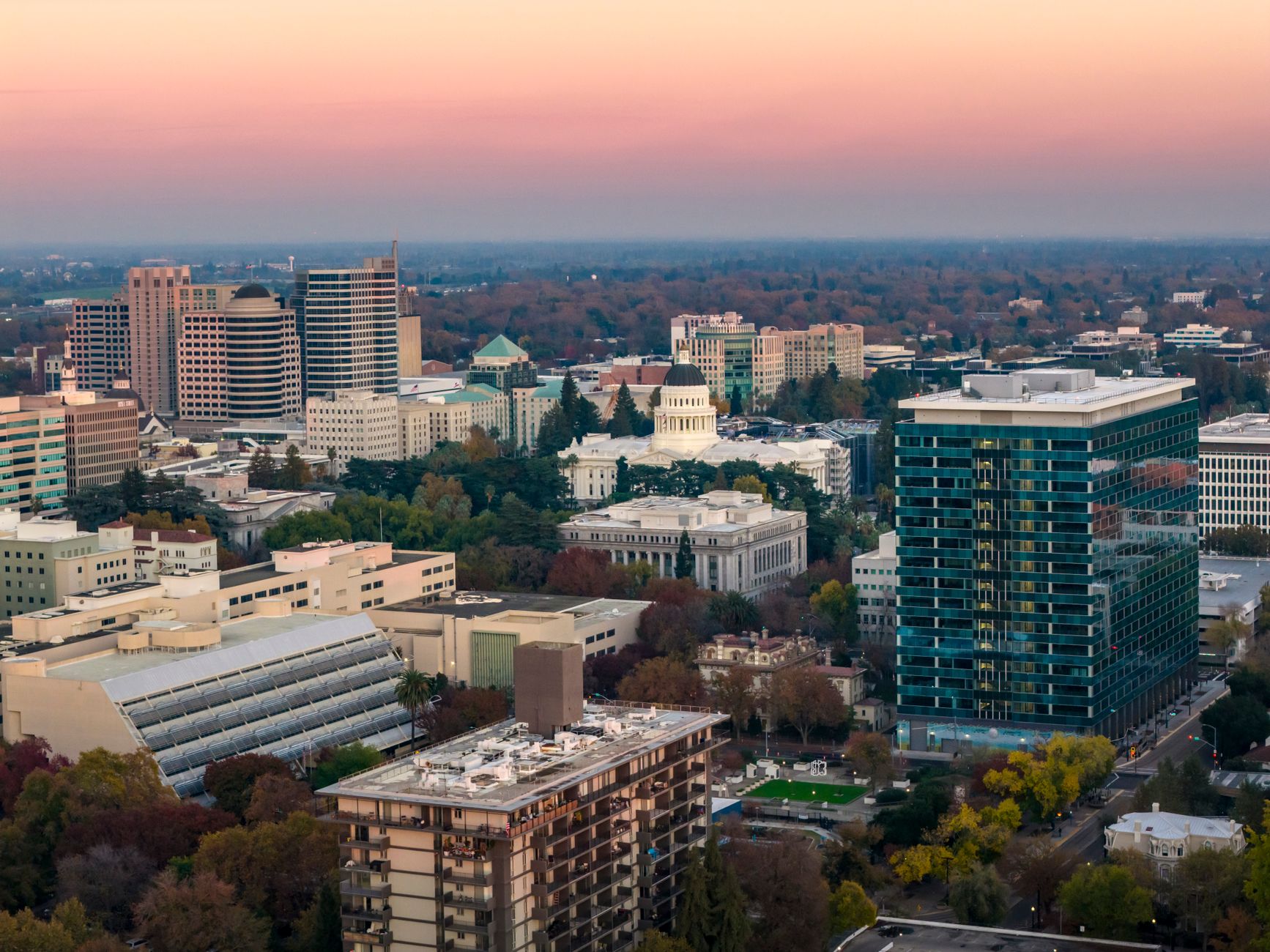 Sacramento skyline with business professionals meeting in a modern office