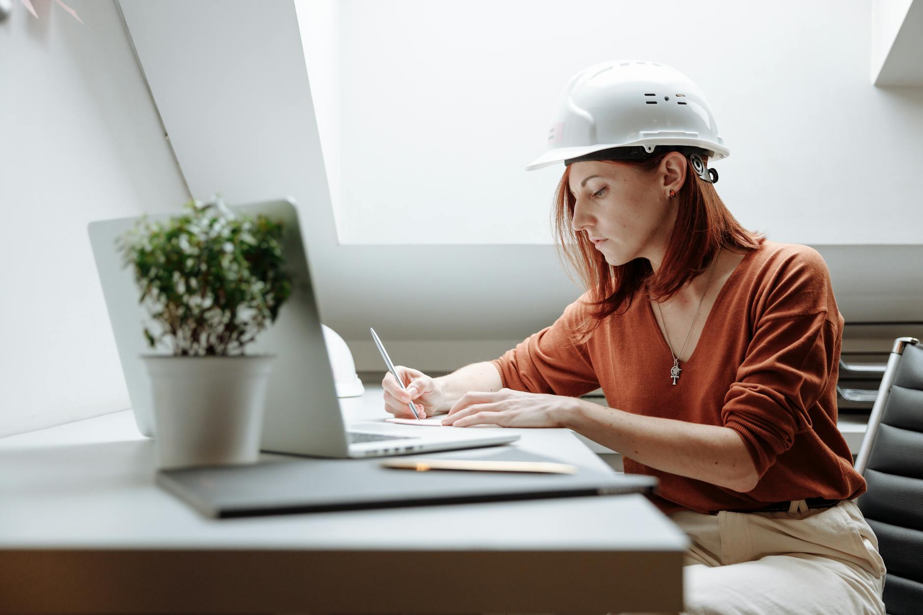 Contractor using laptop for quotes on construction site