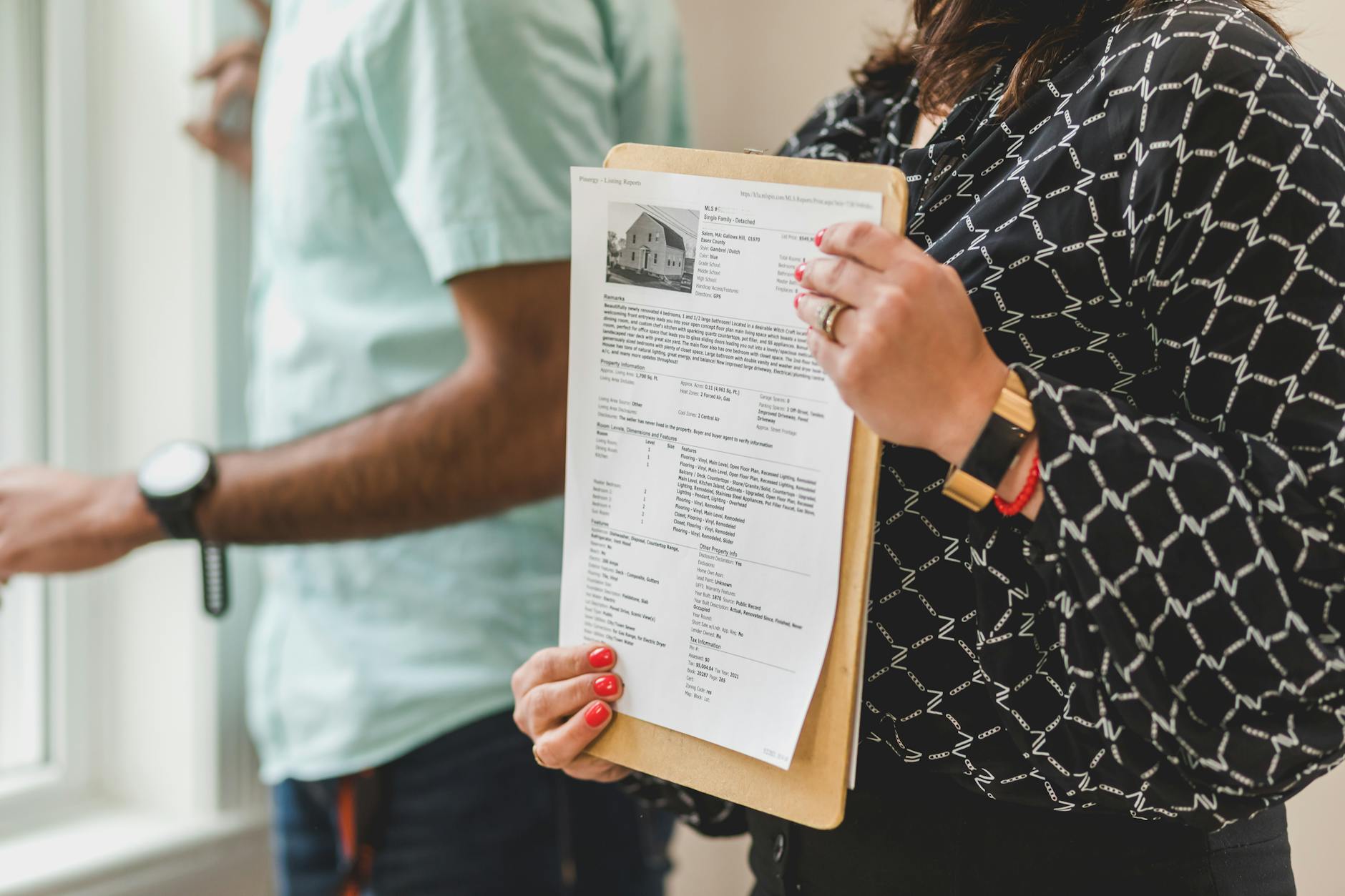 Real estate agent showing neighborhood map to clients