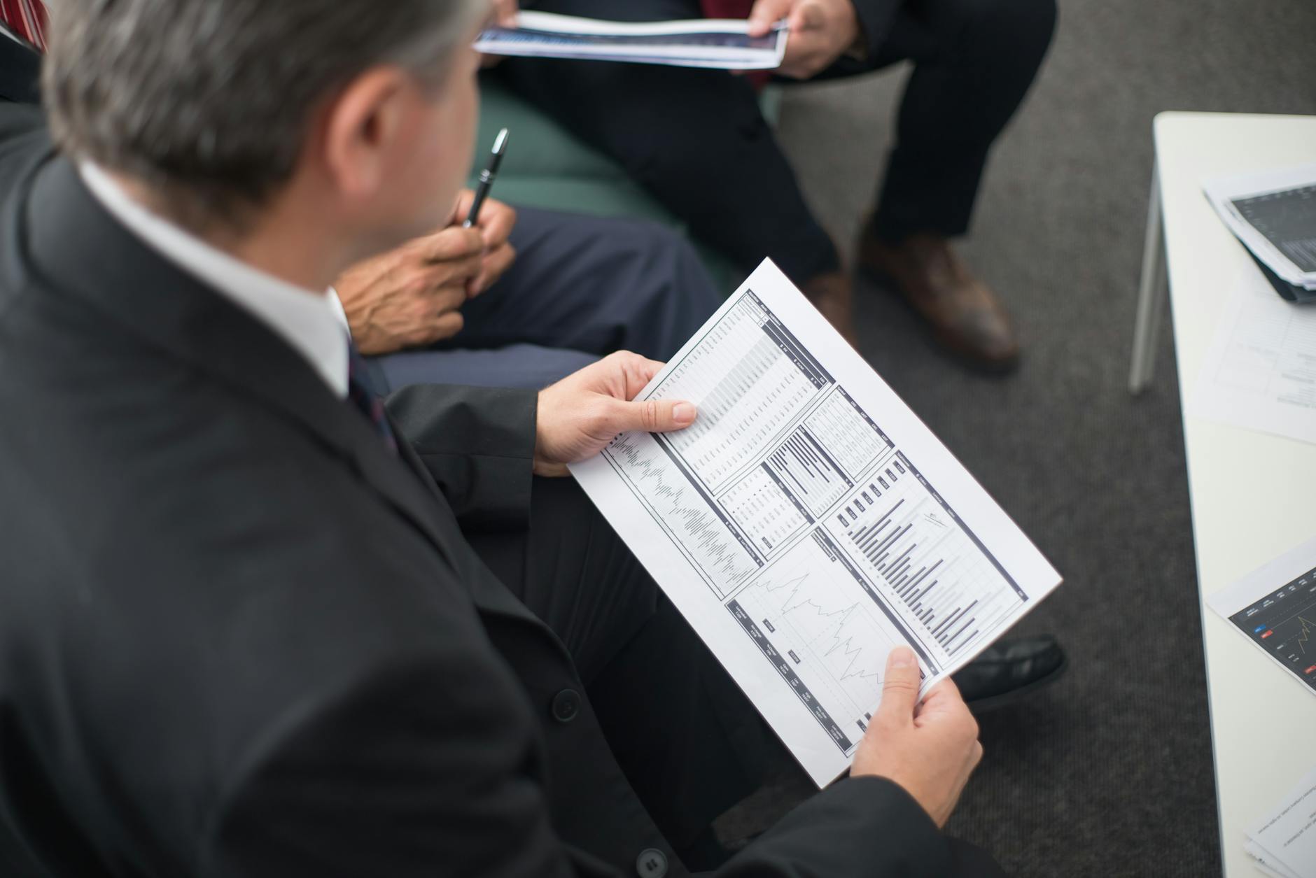 Executive team analyzing sales AI dashboard