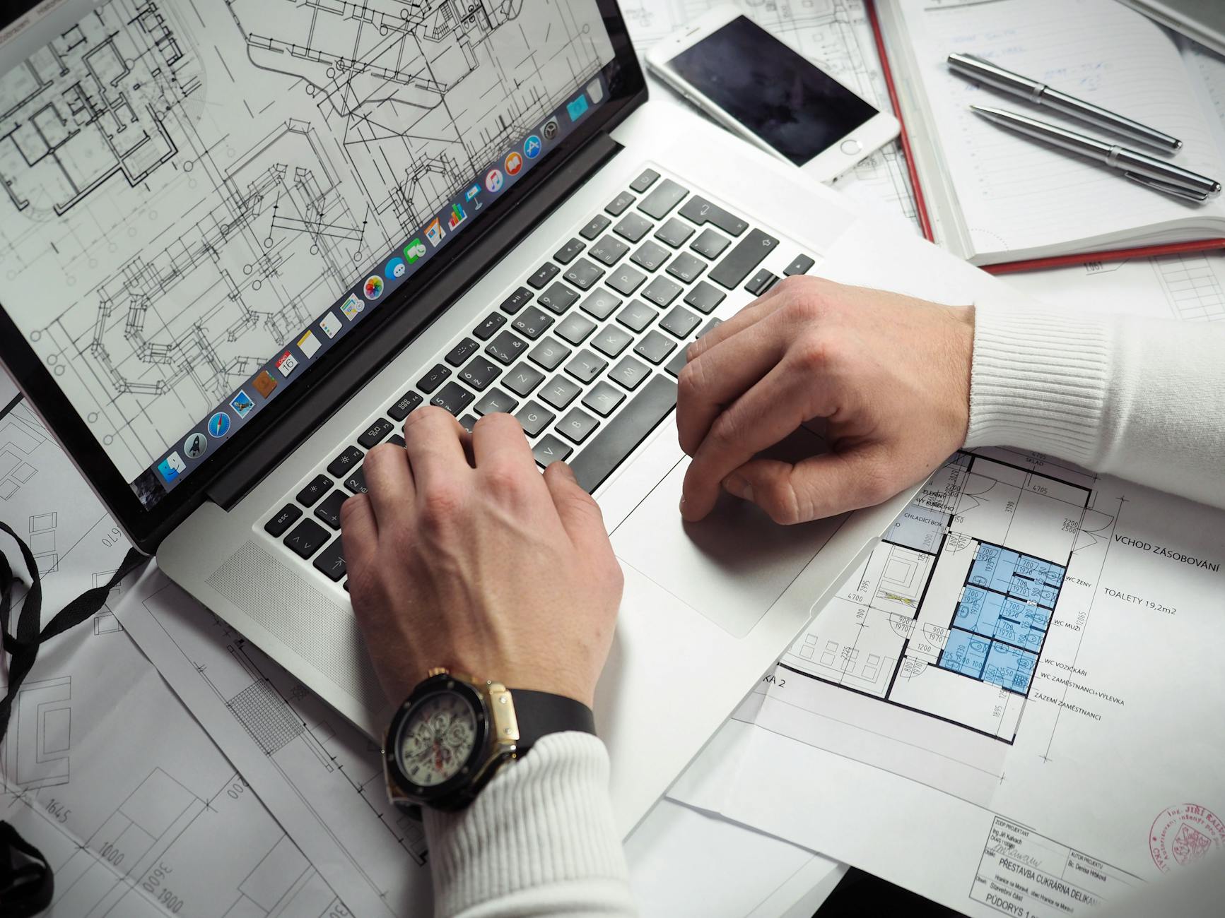 Architect reviewing digital blueprints in modern office