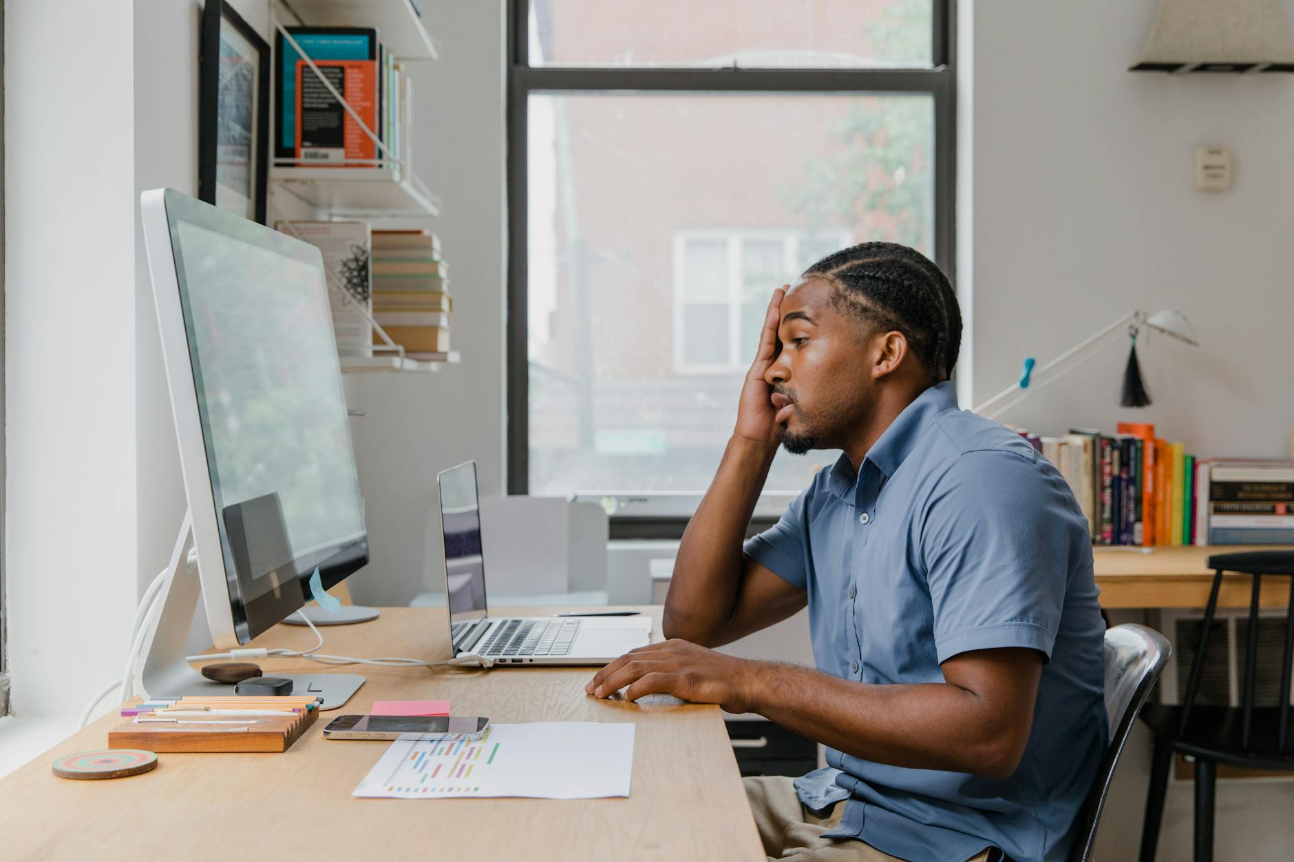 Frustrated salesperson at computer desk