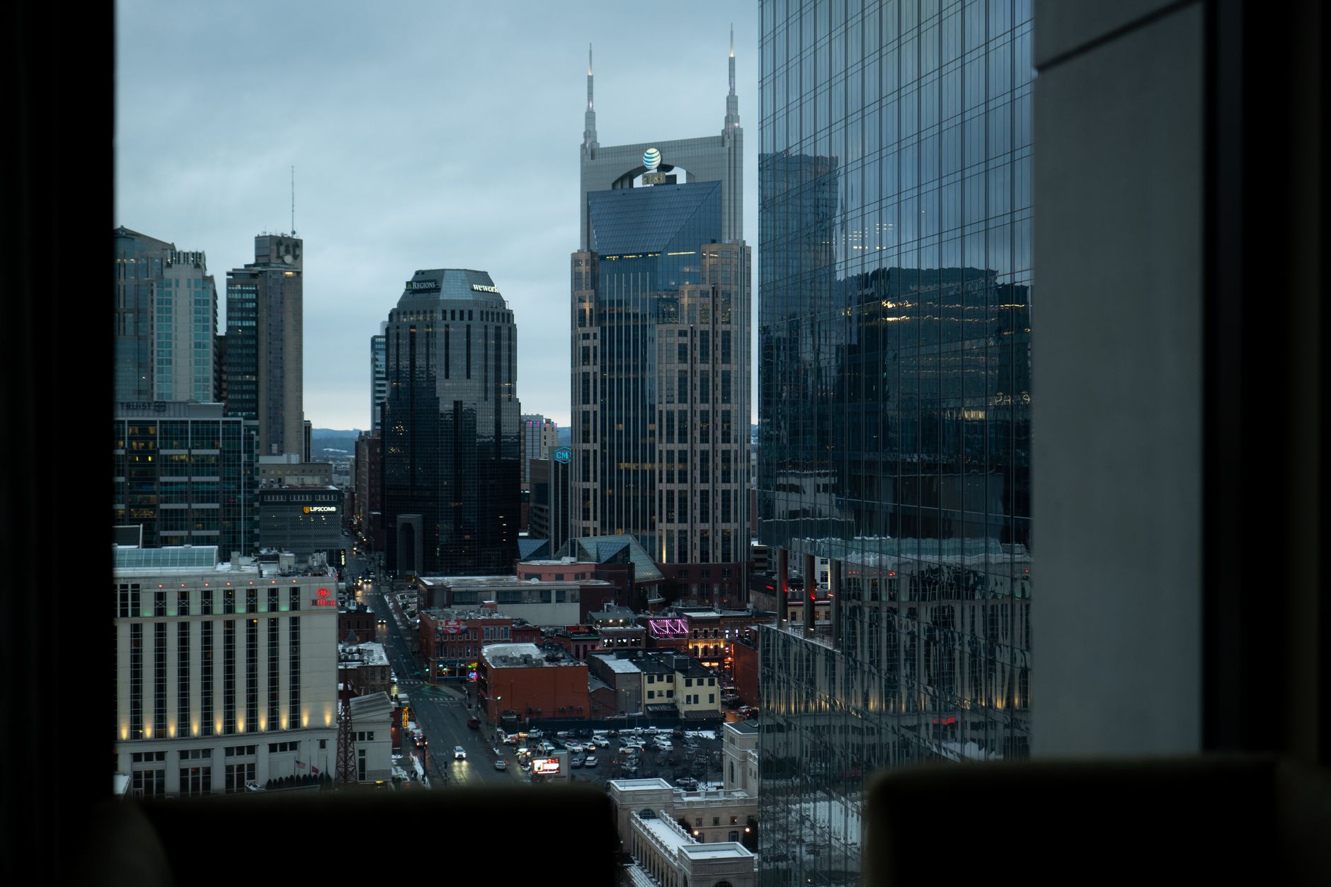Nashville skyline with business professionals meeting over documents