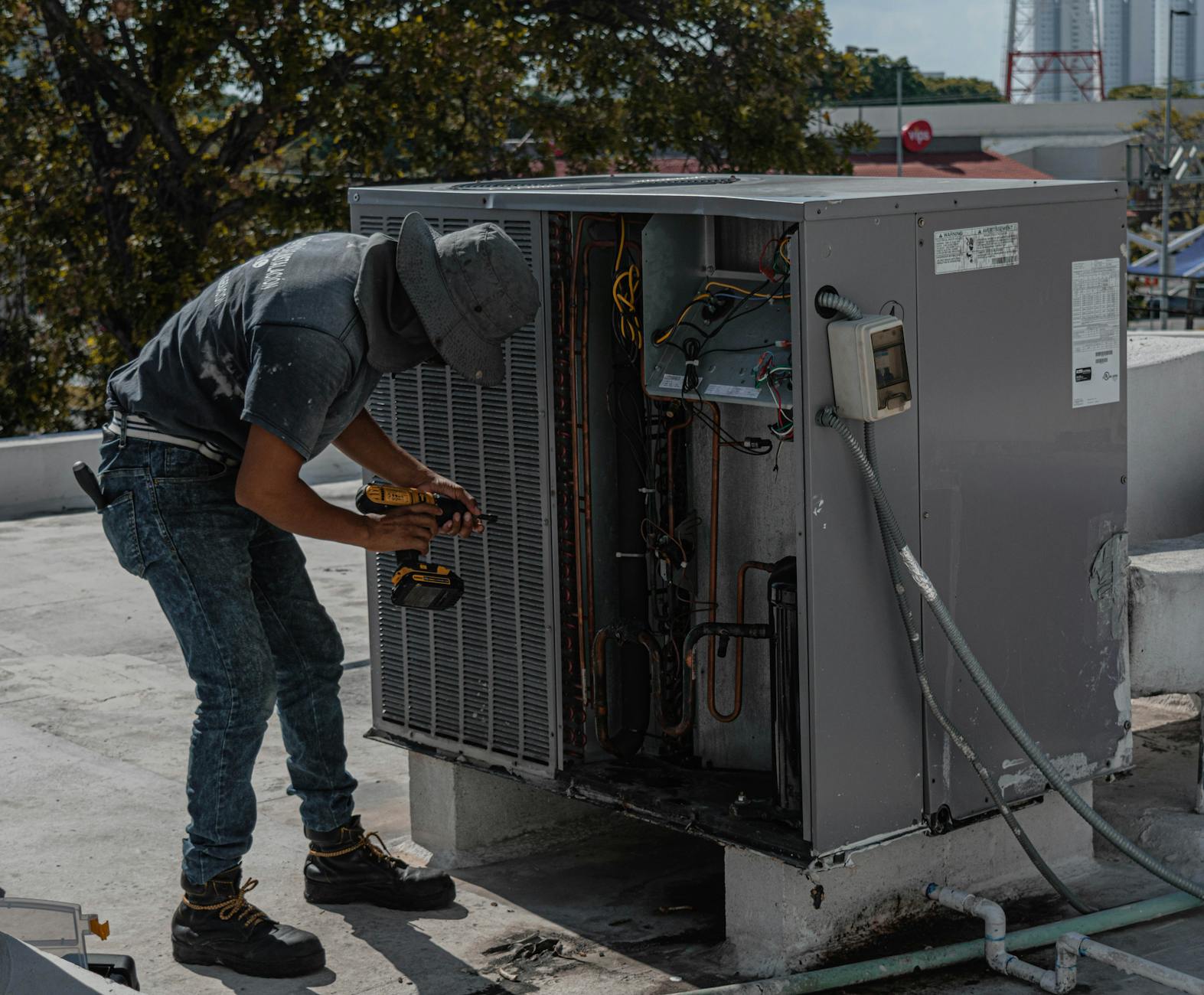 HVAC technician repairing air conditioner unit