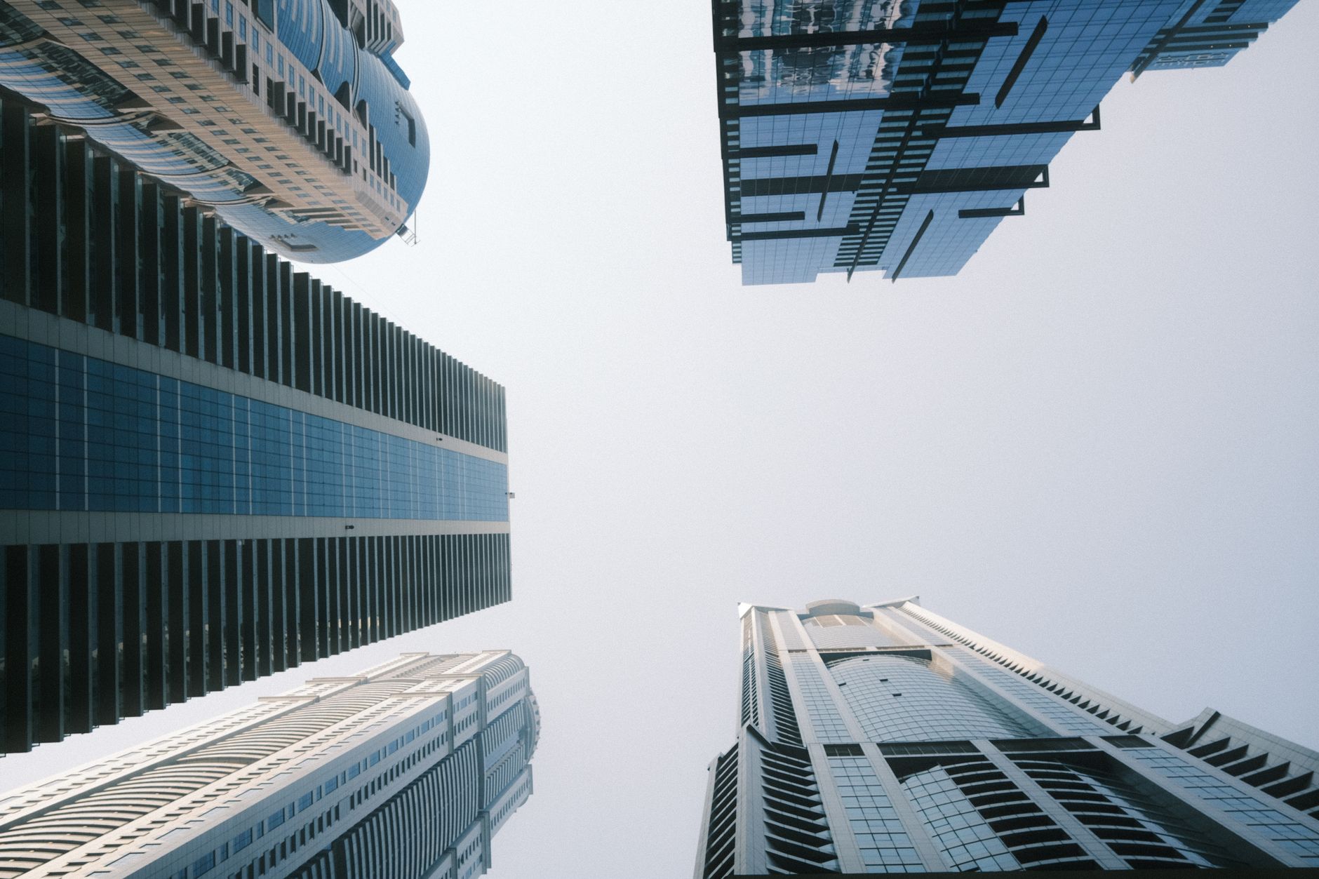 Captivating upward view of modern skyscrapers in Dubai capturing the city's architectural marvels.