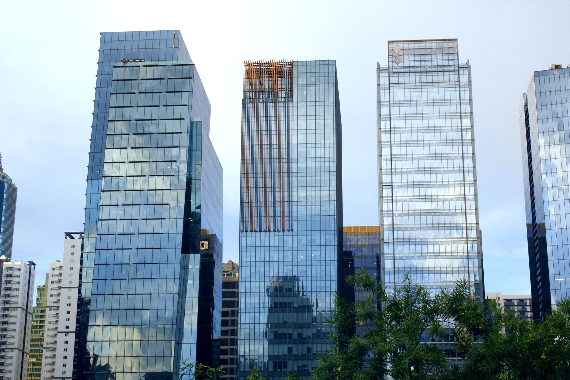 Tall glass skyscrapers with urban reflections in a city skyline. Modern architecture at its finest.