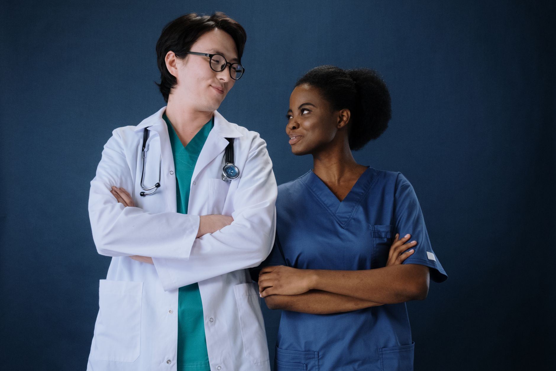 Diverse medical team in uniforms with stethoscopes, conveying teamwork and professionalism.