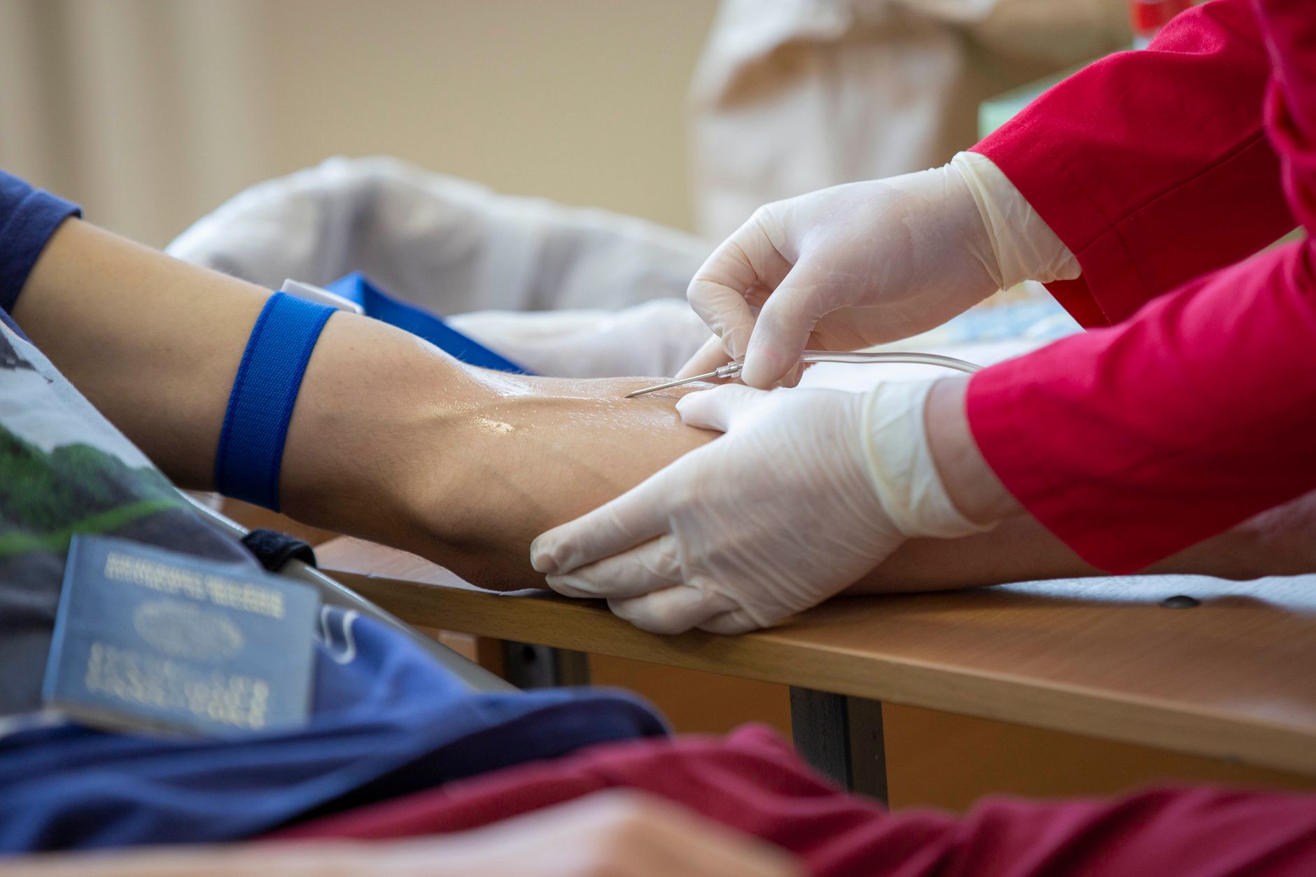 Close-up of a healthcare professional giving an injection to a patient in a hospital setting.