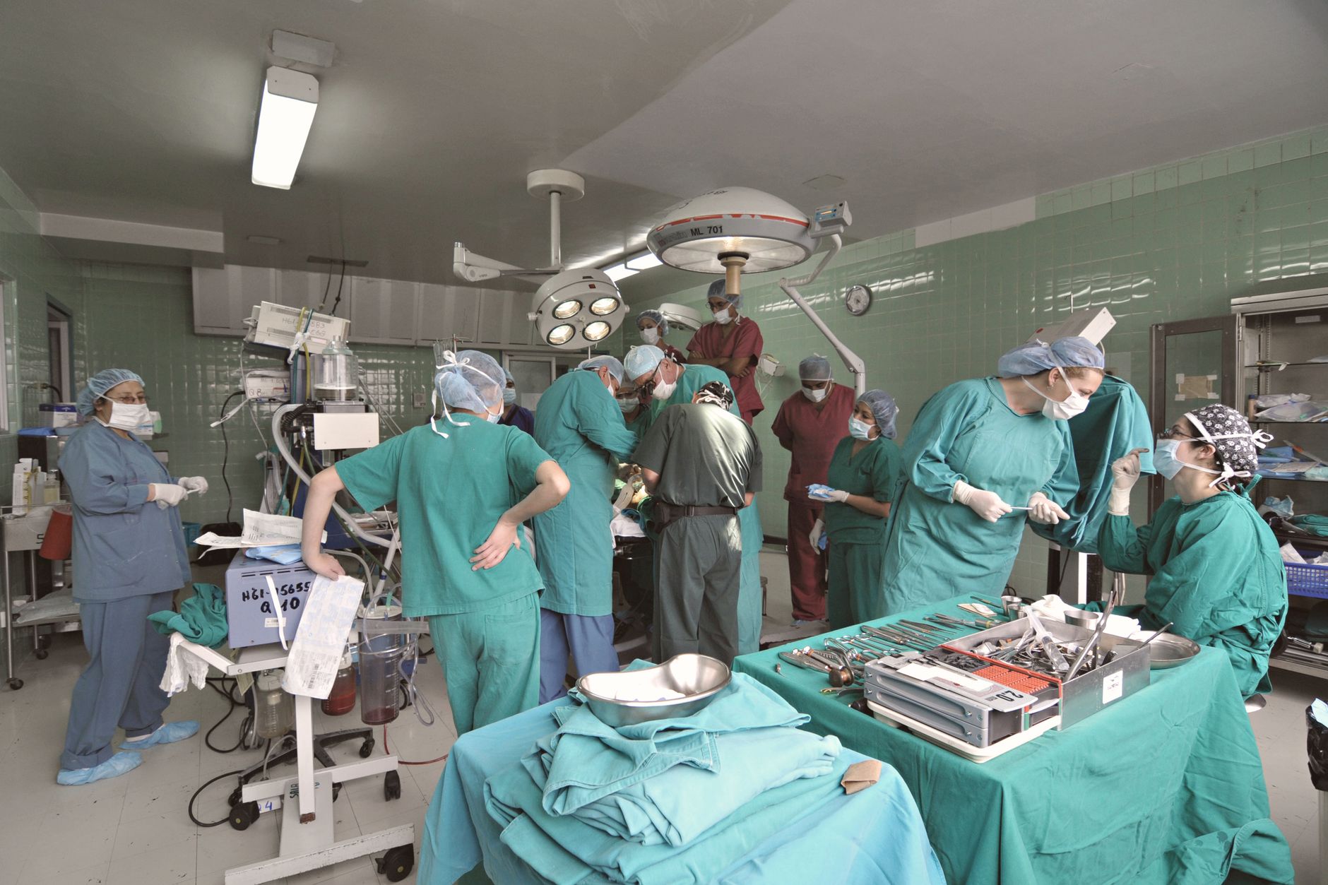 Surgeons and medical staff working together in a hospital operating room during surgery.