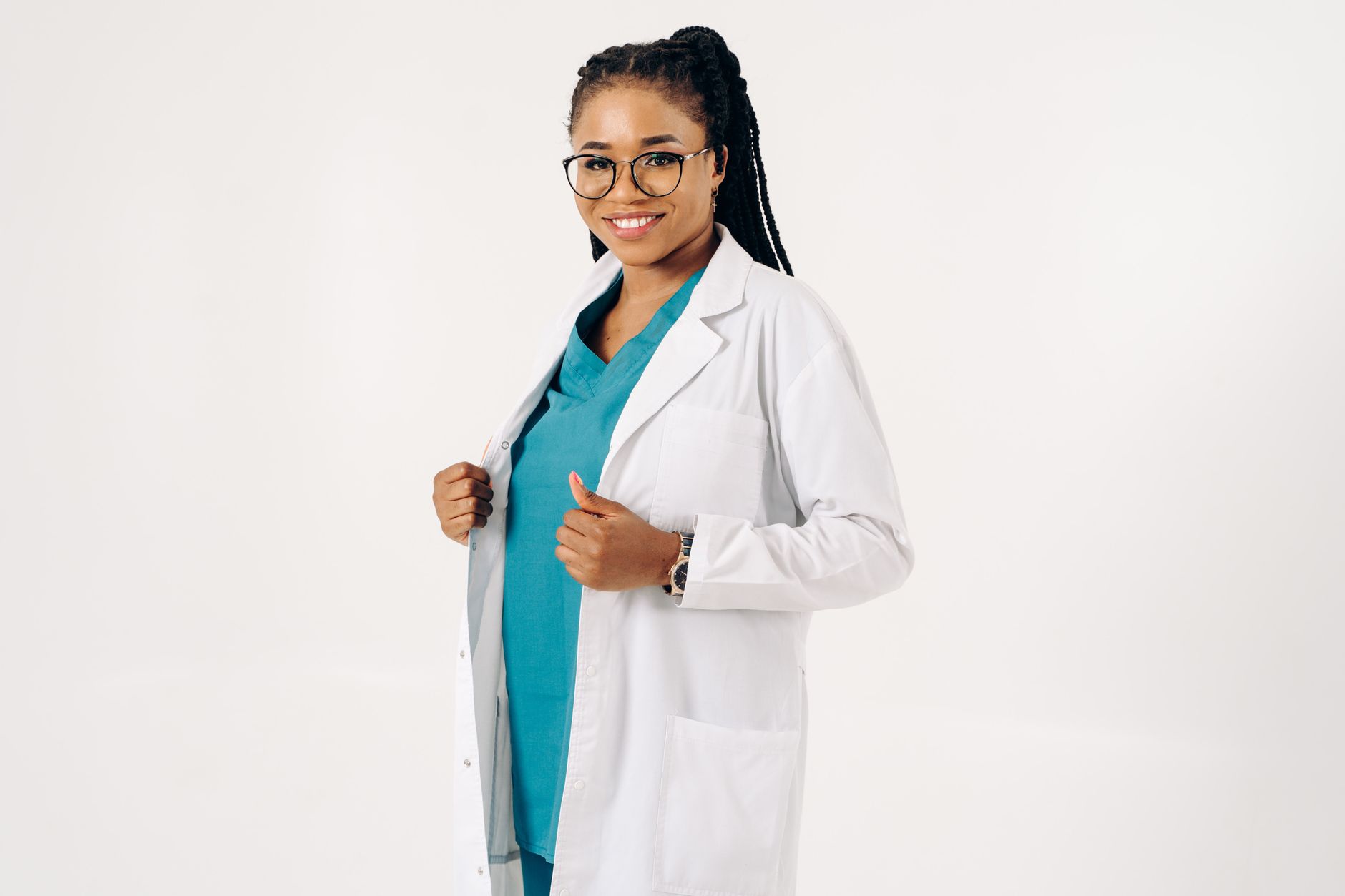 Confident female doctor wearing eyeglasses and lab coat, smiling against a white background.