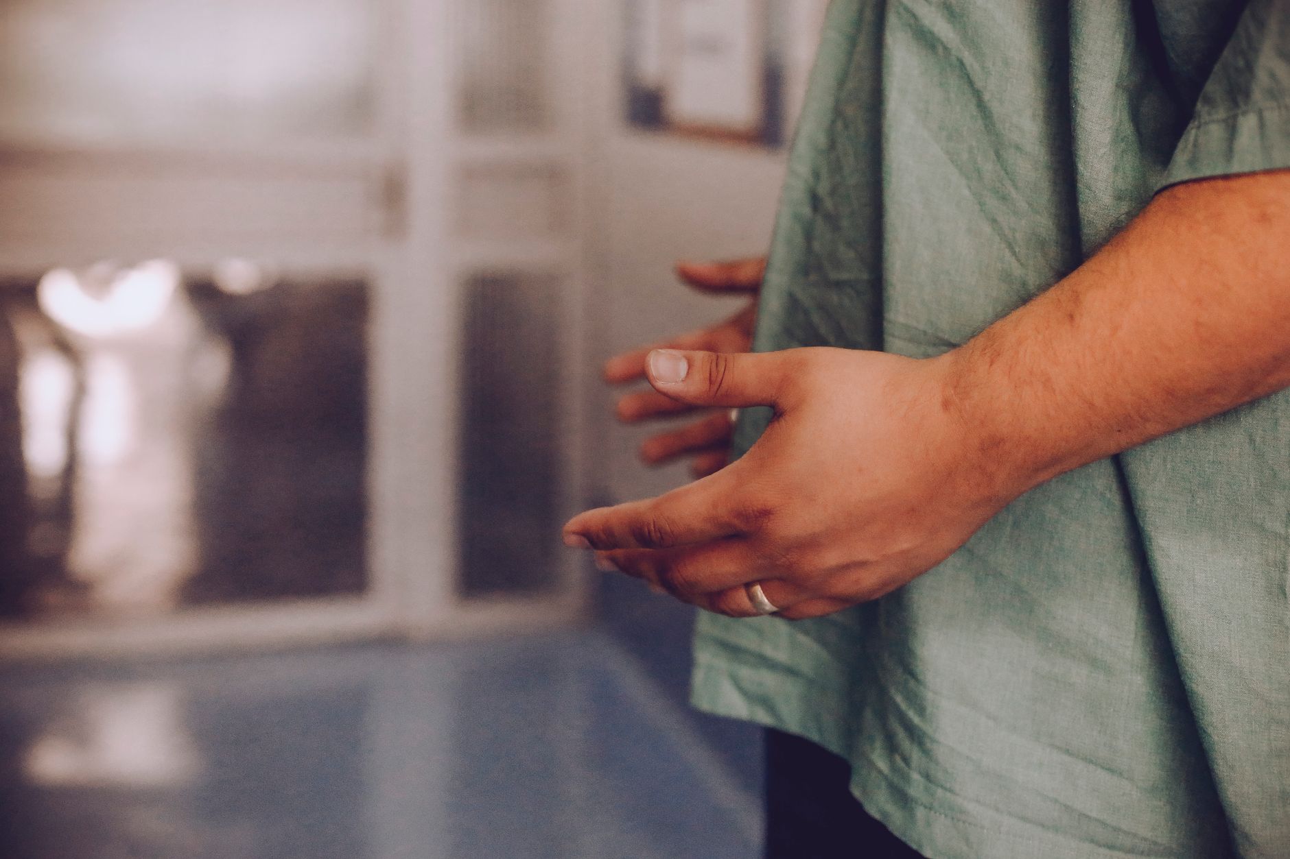 A close-up of a person's hands in a hospital setting, emphasizing care and comfort.