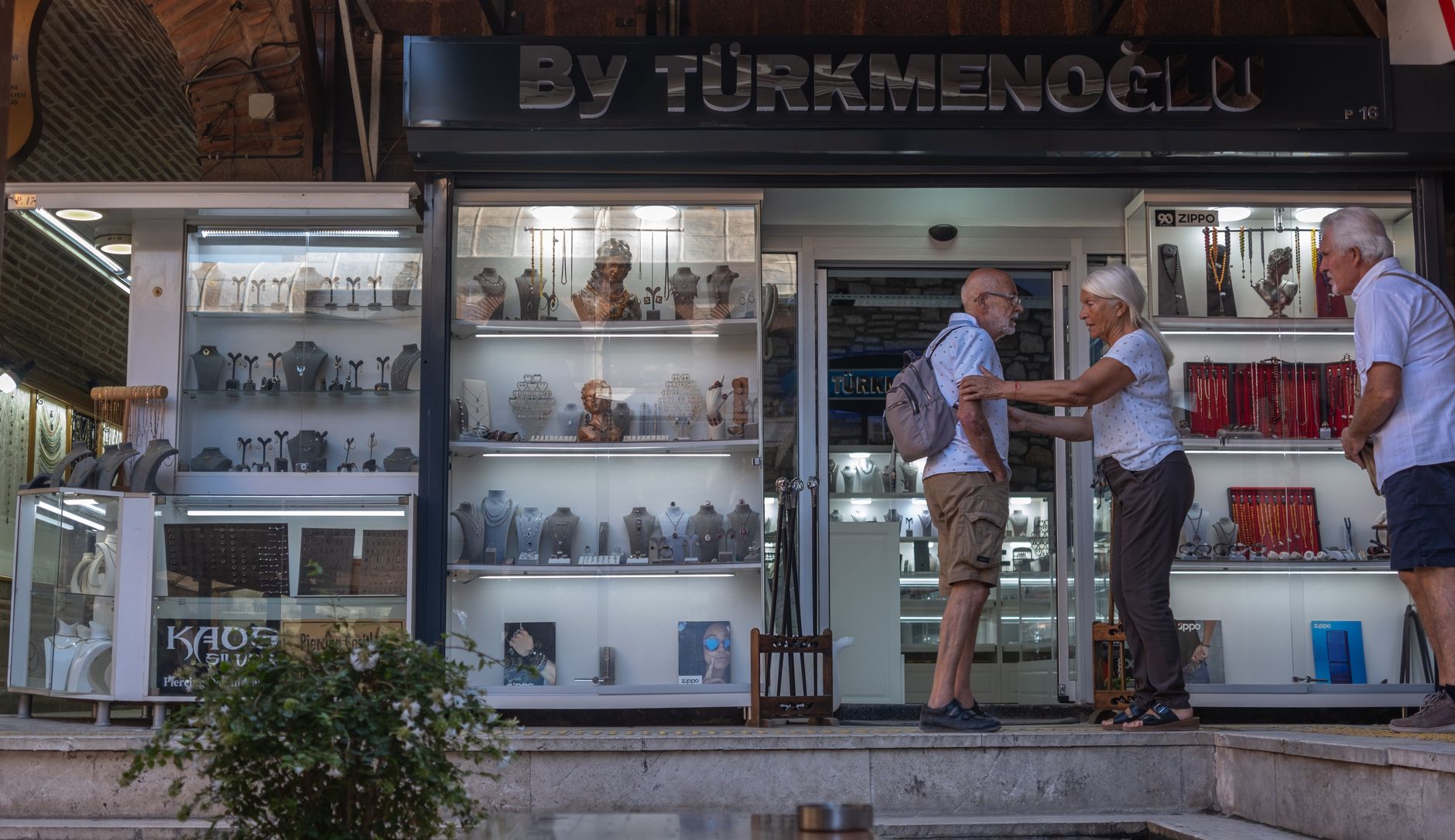 Elderly couple at a jewelry store in İzmir's bustling bazaar.