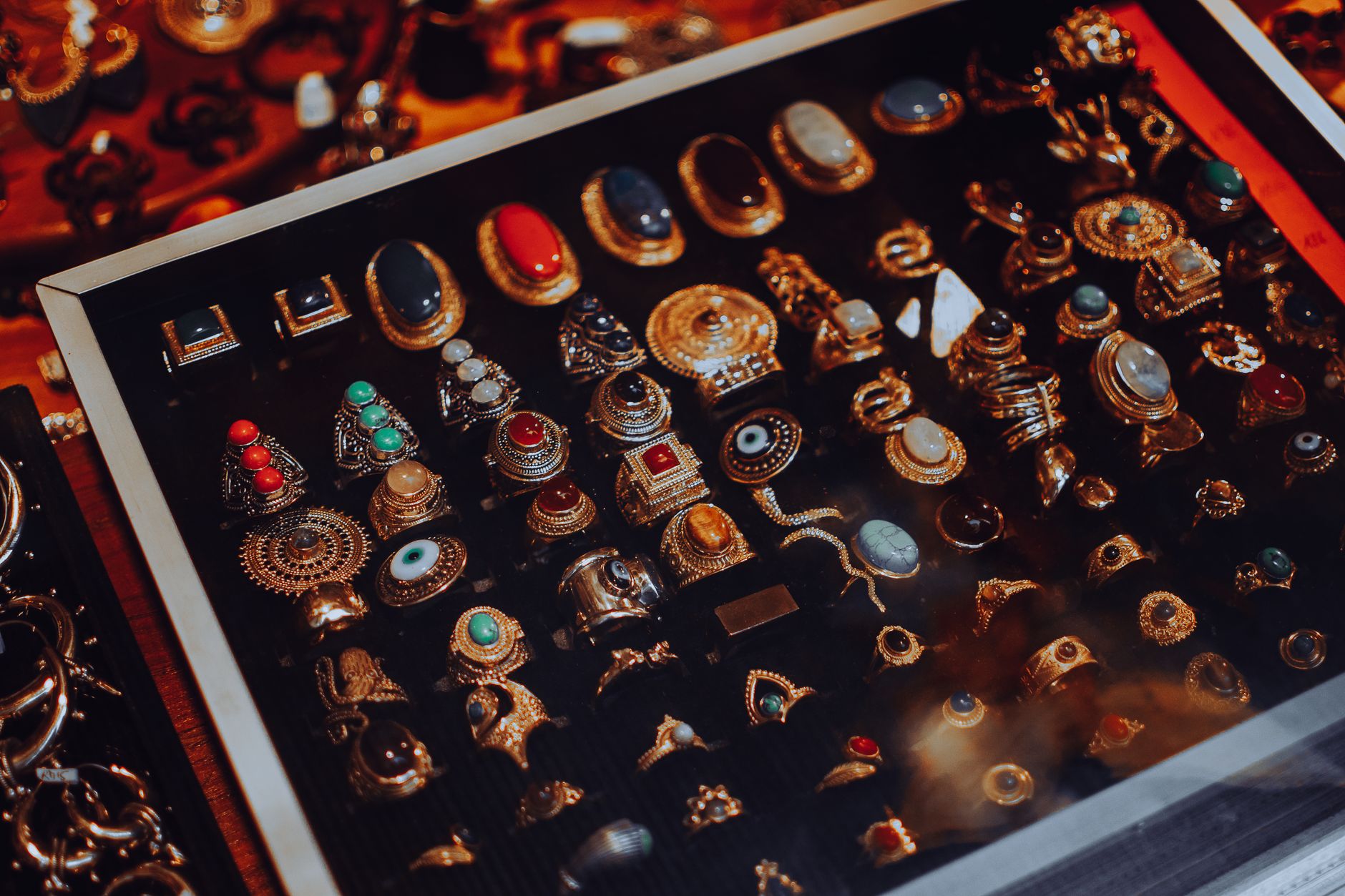 Showcase of vintage jewelry with ornate designs in a glass display case.