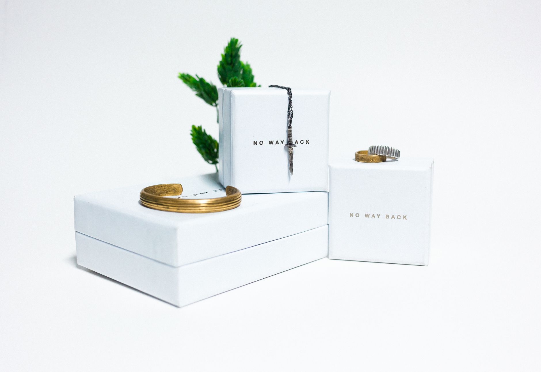 Minimalist display featuring elegant jewelry on white boxes, ideal for upscale presentations.