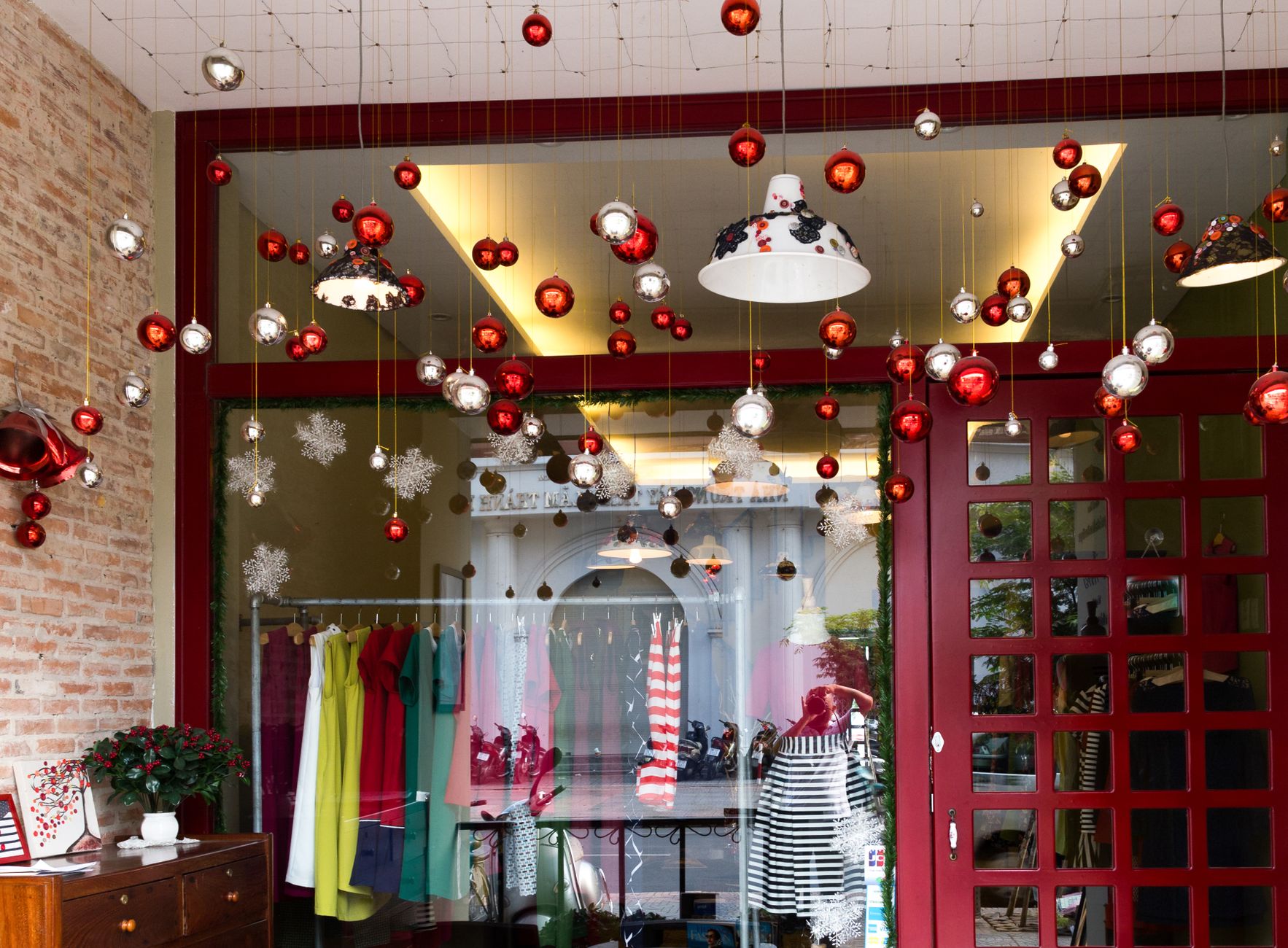Elegant boutique showcasing colorful fashion amidst festive holiday decor. Perfect blend of style and celebration.