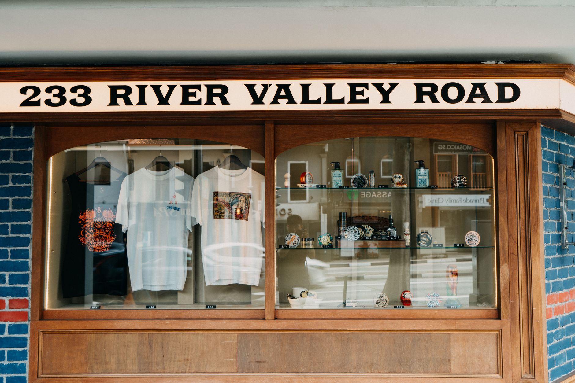 A charming vintage shop display features unique t-shirts and souvenirs on River Valley Road.