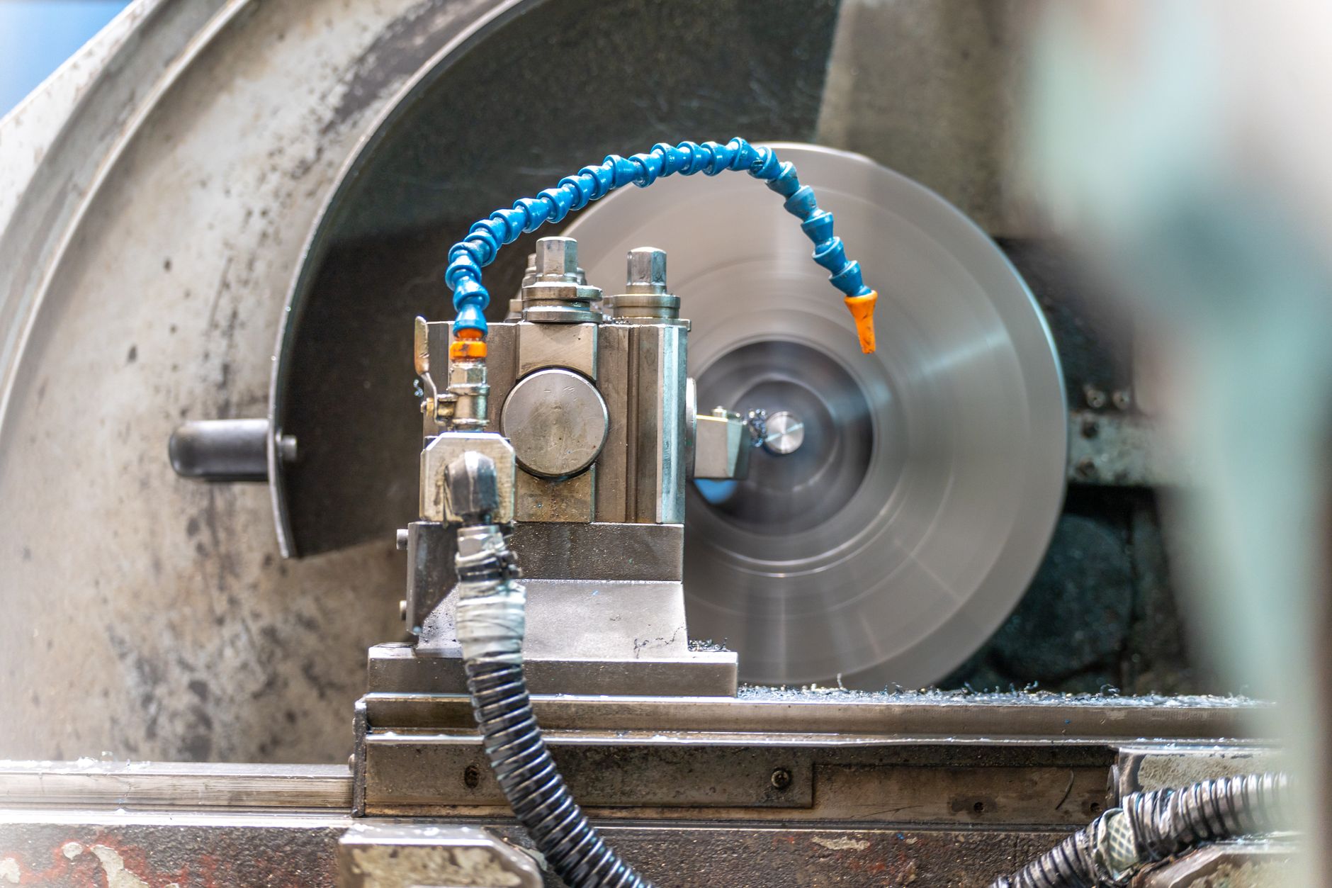 Close-up of a spinning lathe machine in an industrial workshop setting.