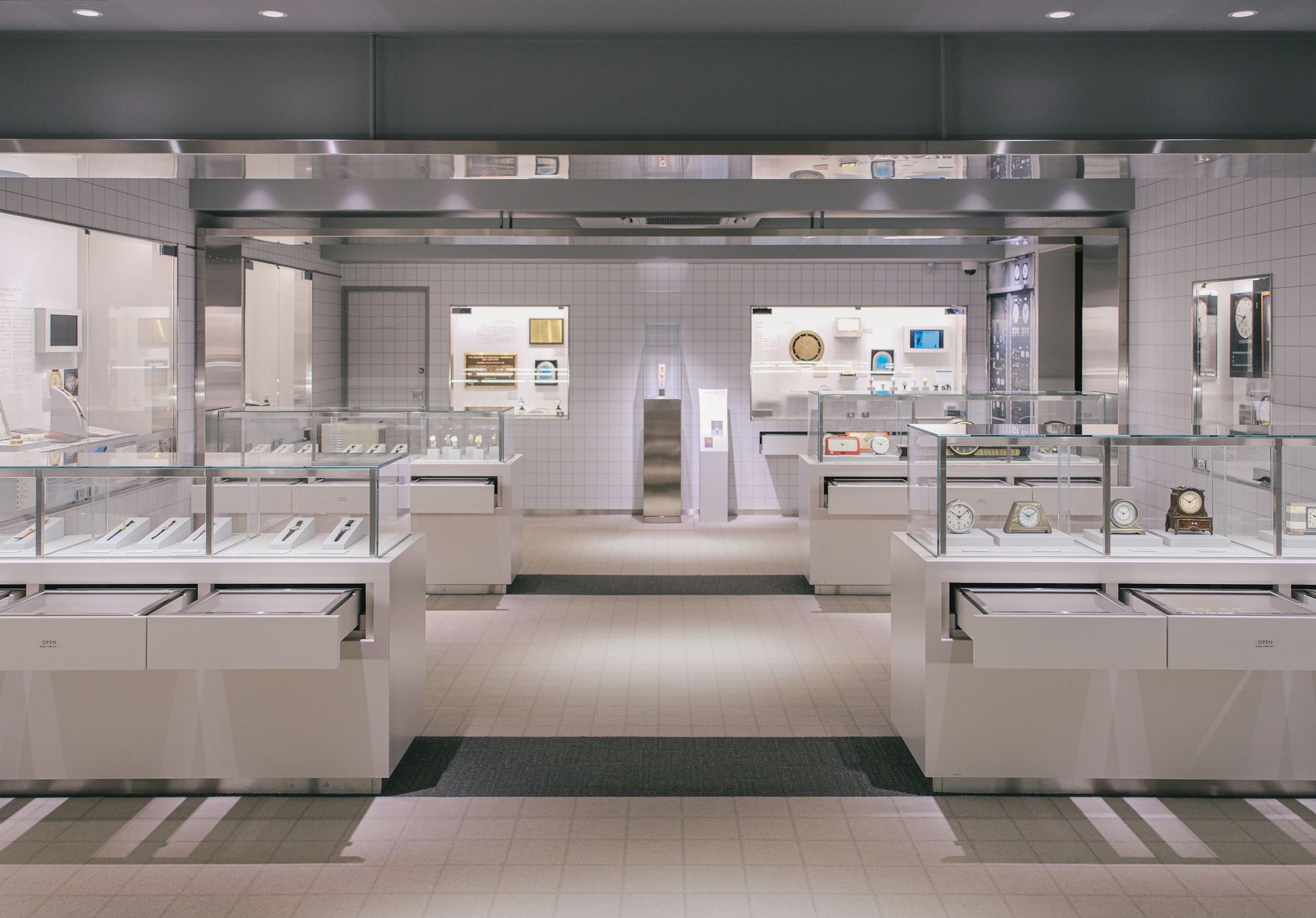 Luxurious watch showroom with elegant glass displays and modern design.