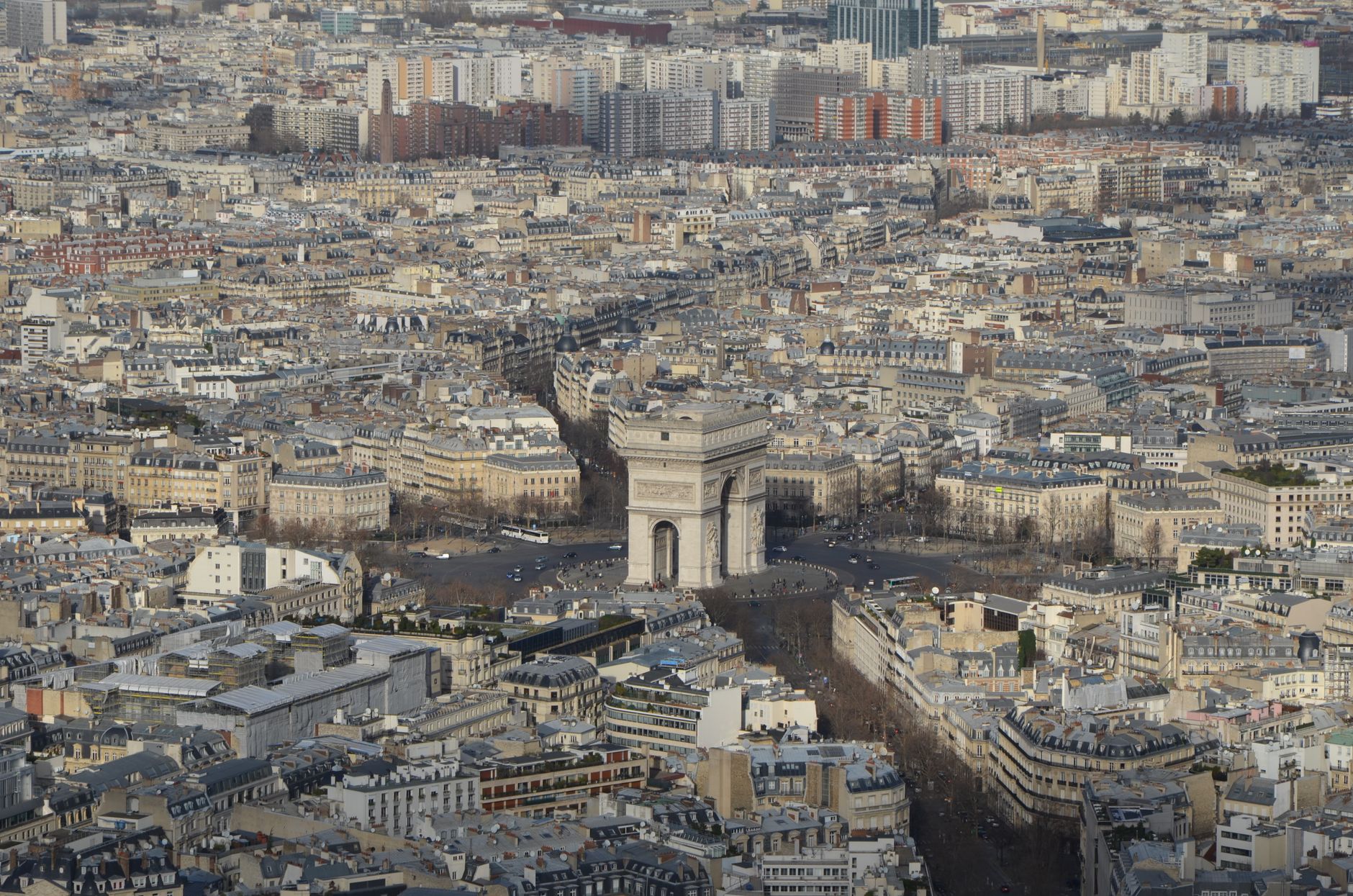 A stunning aerial view of the iconic Arc de Triomphe surrounded by the cityscape of Paris.