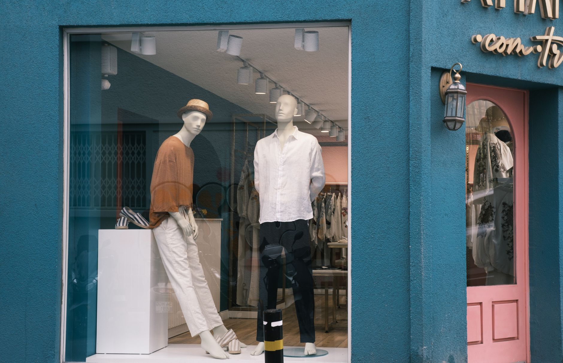 Mannequins showcasing stylish apparel in a boutique window display.