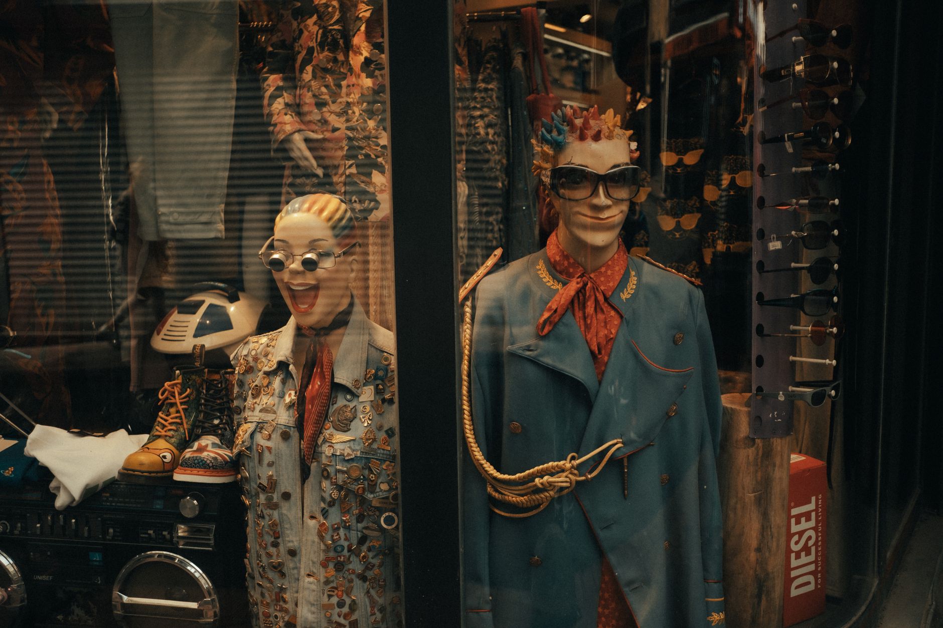 Quirky mannequins adorned in eclectic fashion pieces inside a vibrant store display.