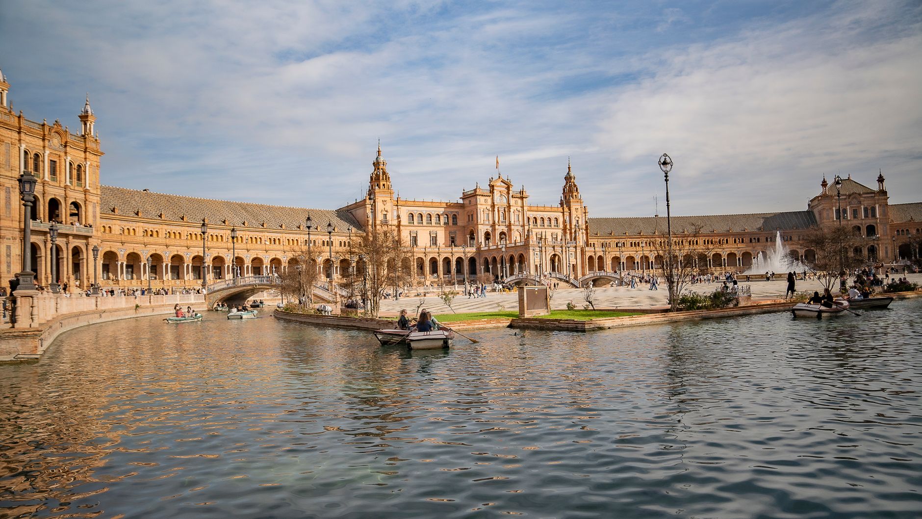 Explore the architectural beauty of Plaza de España in Seville, Spain, under clear skies.