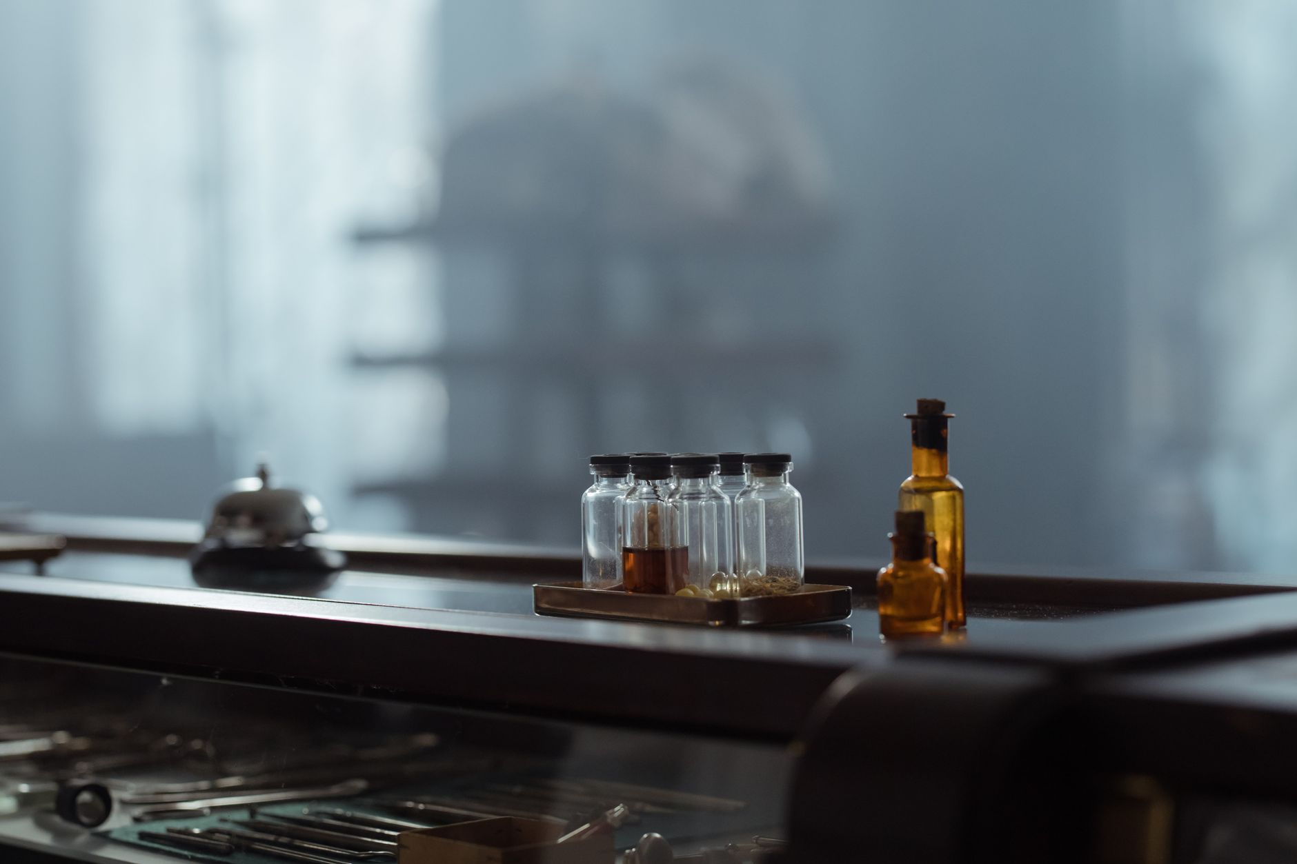 A collection of vintage glass bottles in a dimly lit laboratory setting, exuding an antiquated charm.