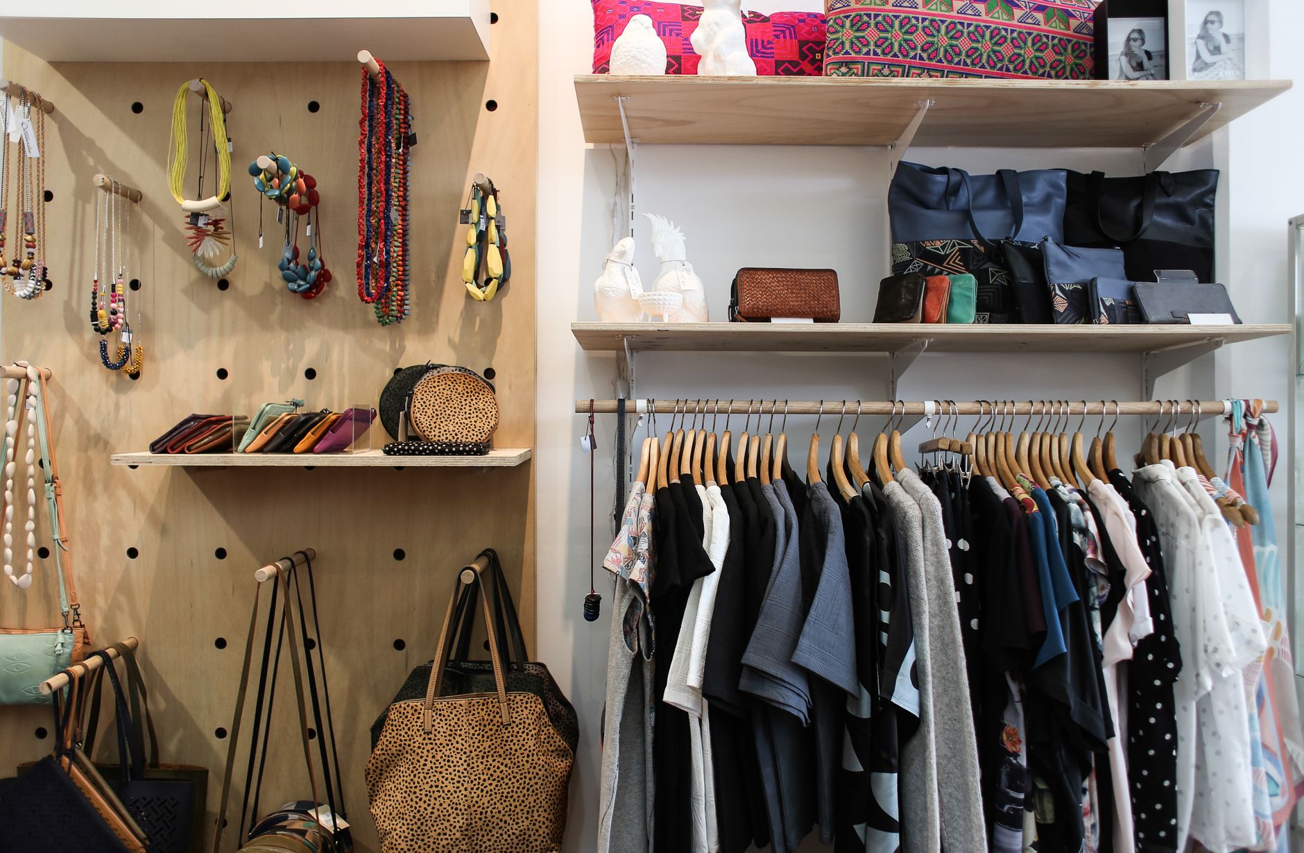 Neatly arranged clothing and accessories in a stylish wardrobe setup.