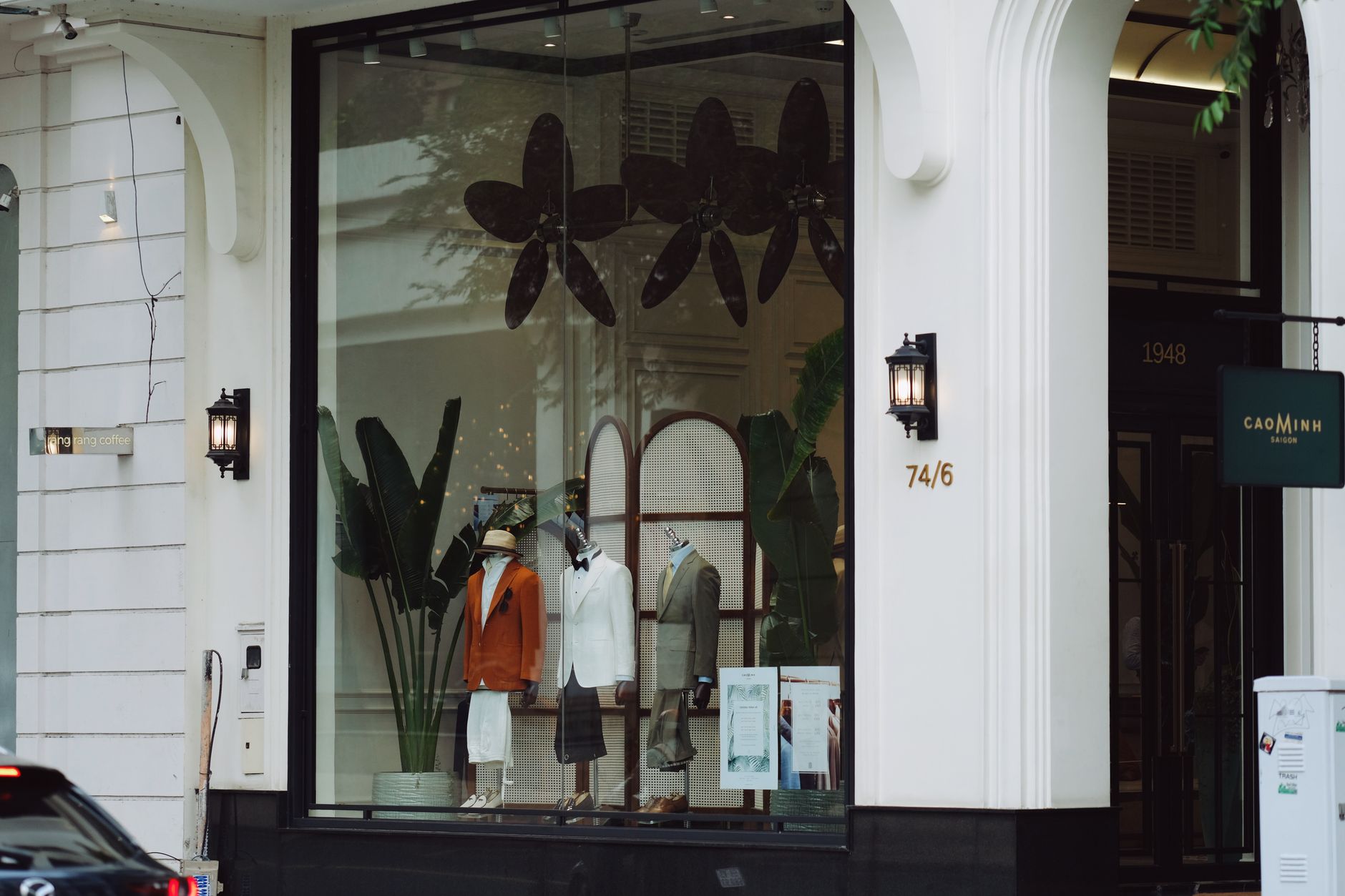 Stylish fashion boutique display with elegant mannequins and decor in a modern storefront.