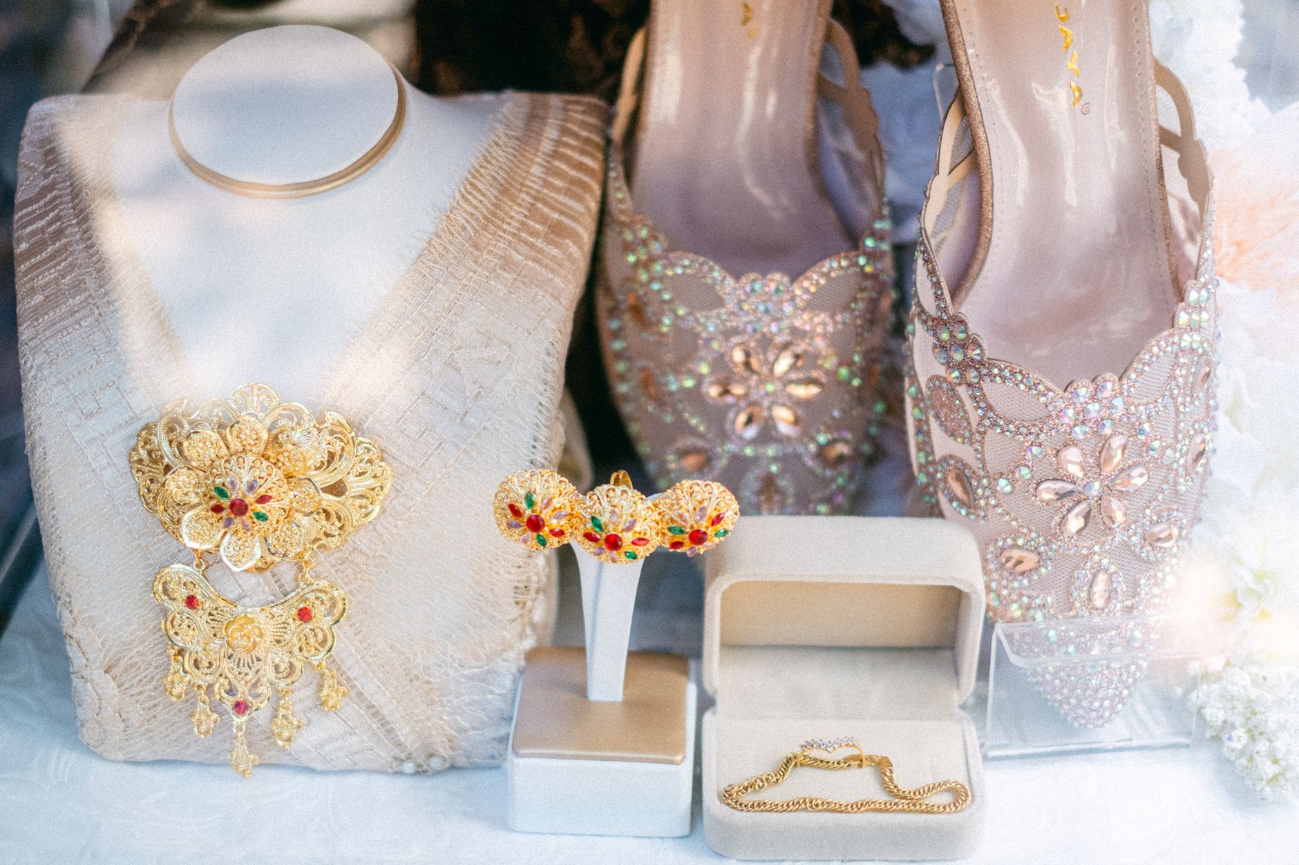 Chic collection of ornate jewelry and embellished shoes displayed elegantly in a boutique setting.