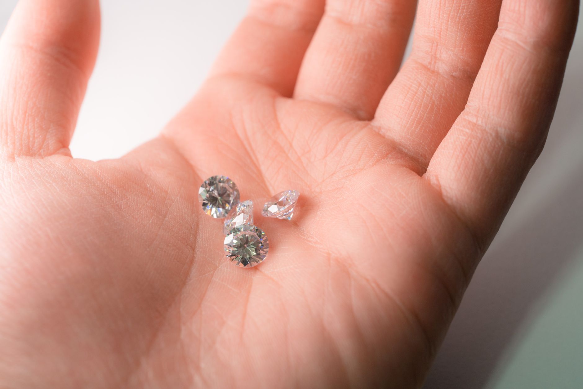 Glistening diamonds resting in the palm, showcasing luxury and elegance.