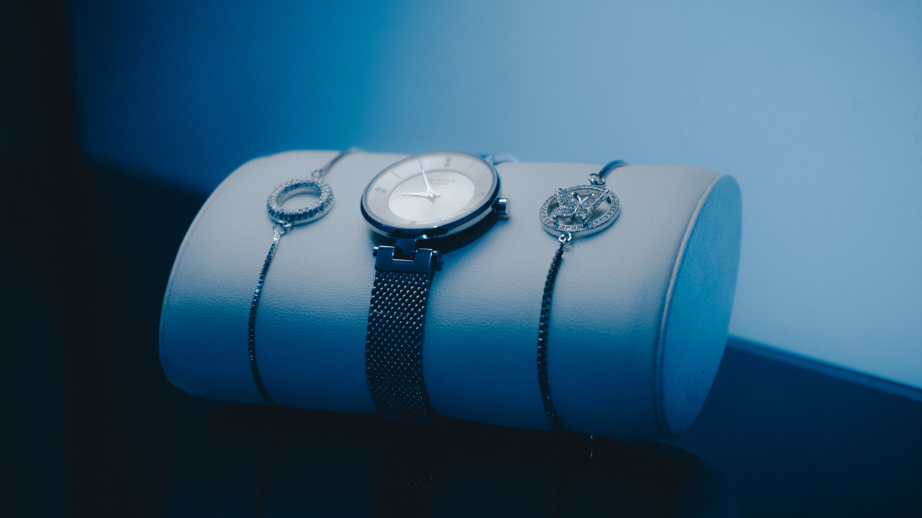 Luxury wristwatch and jewelry on display, showcasing elegance and style.