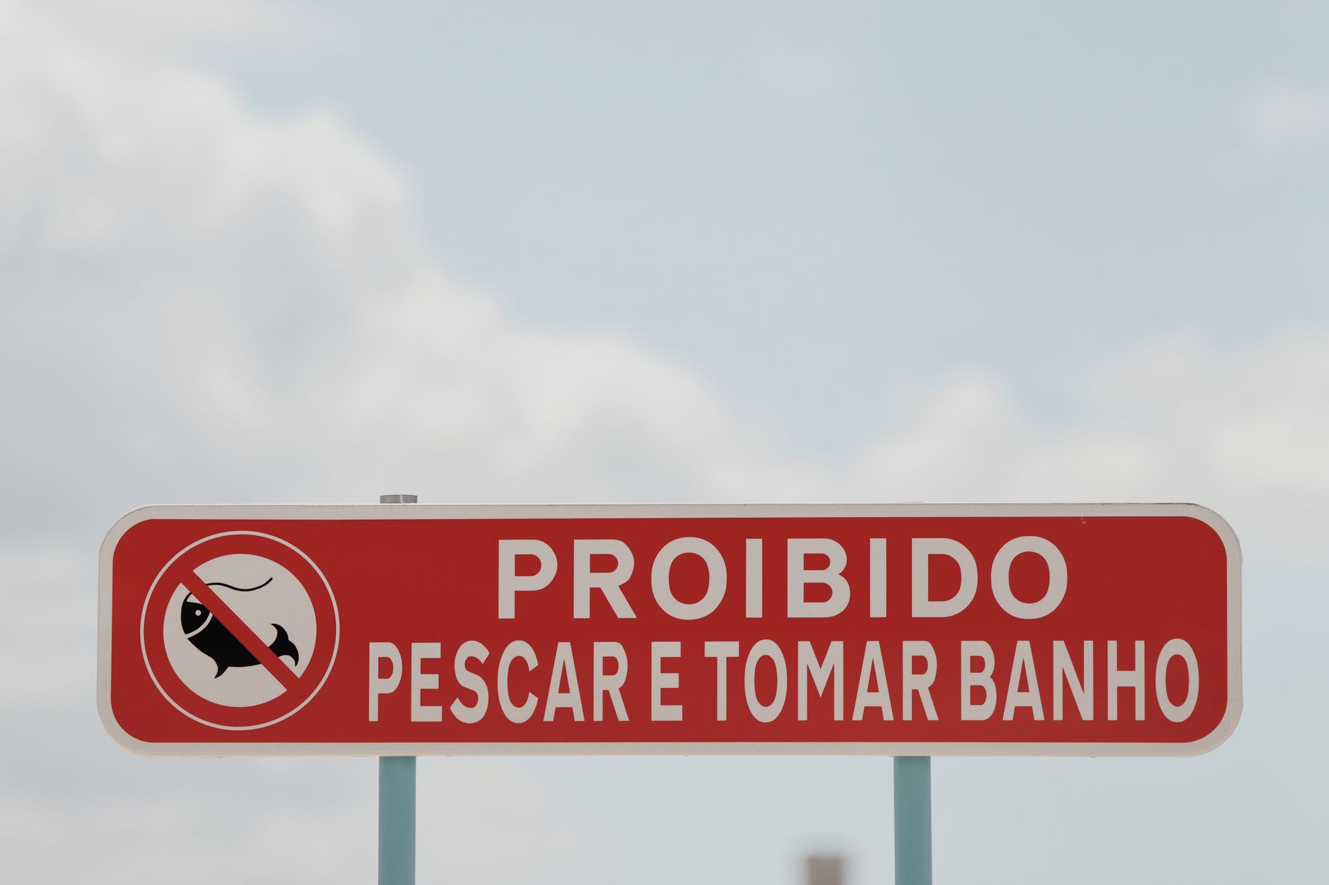 Red prohibition sign in Lisbon, Portugal forbidding fishing and bathing.