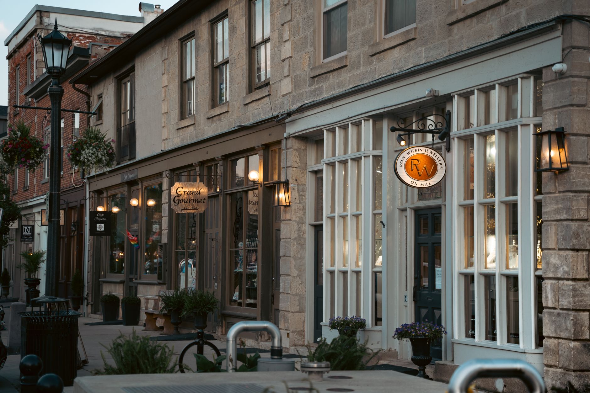 Quaint Ontario street with boutique shops and historic architecture in soft lighting.