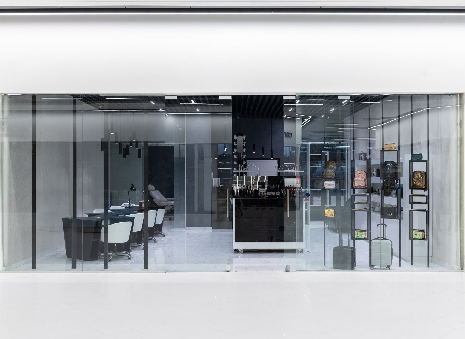 Sleek interior of a modern store with glass facade, stylish furniture, and display items.