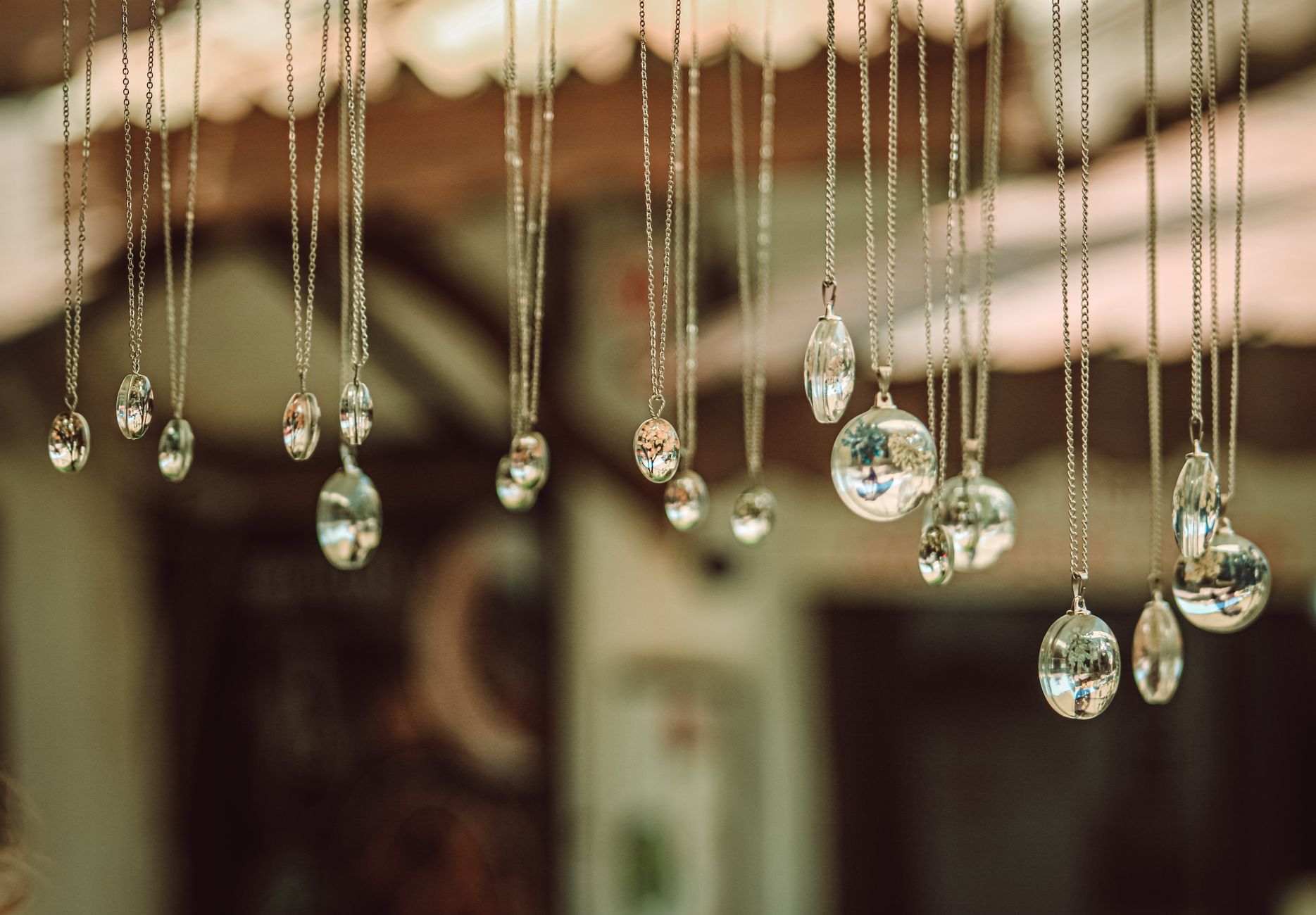 Close-up of hanging glass pendants reflecting light in an artistic display.
